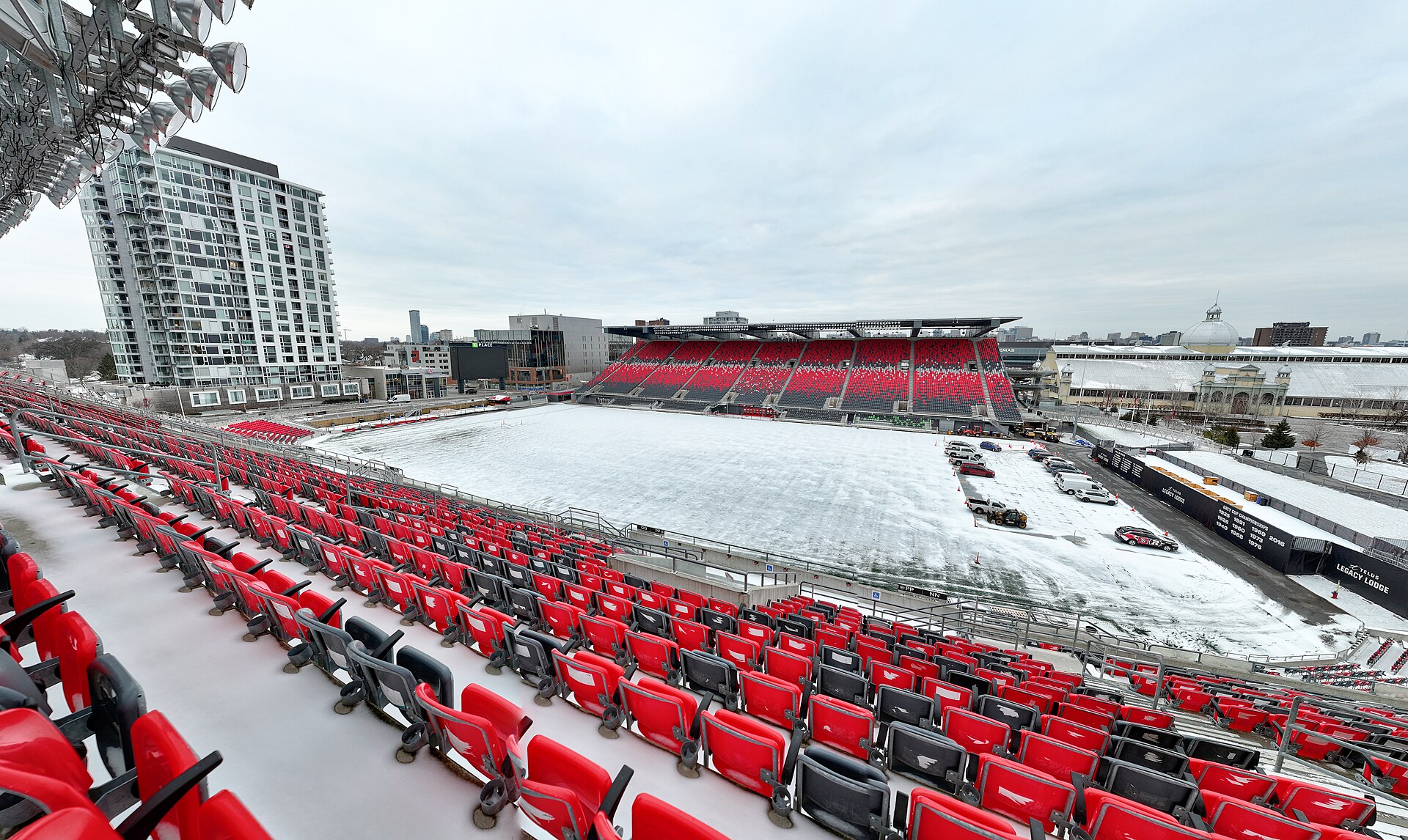 TD Place Stadium in Ottawa with red seats and a snow-covered field
