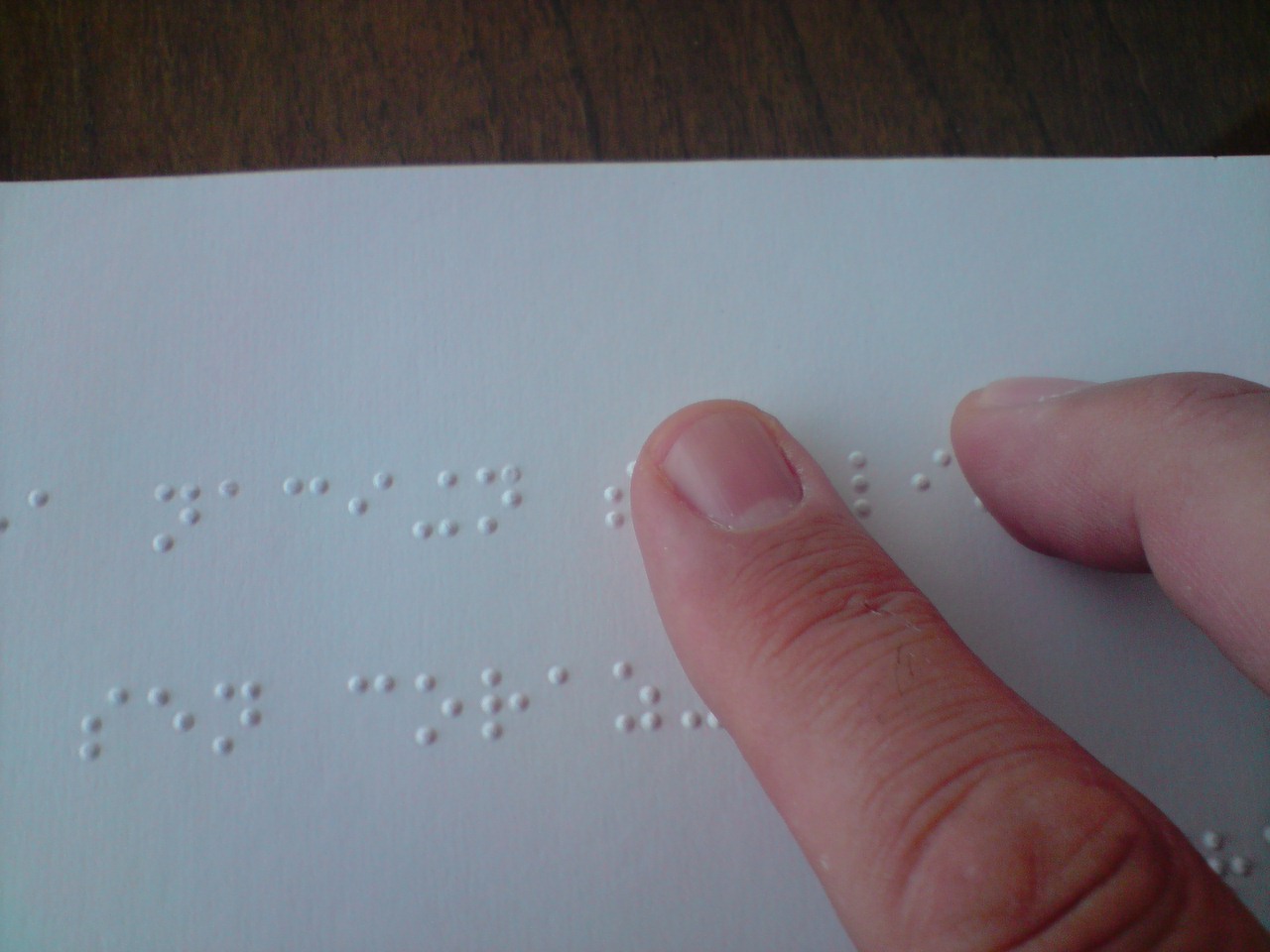 A person reading a braille book