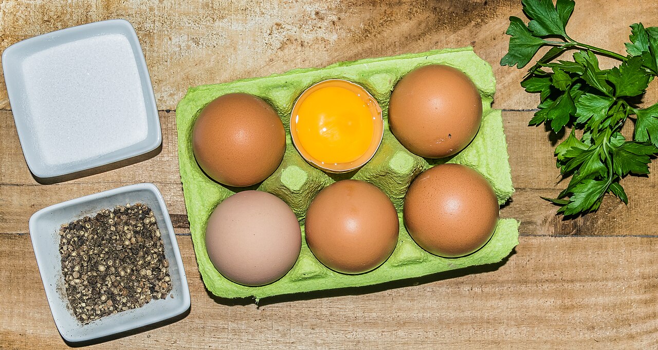 Egg cartons filled with chicken eggs, stored cold to slow aging
