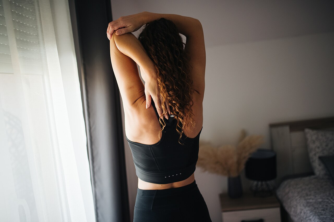 A woman performing a stretching exercise for the spine