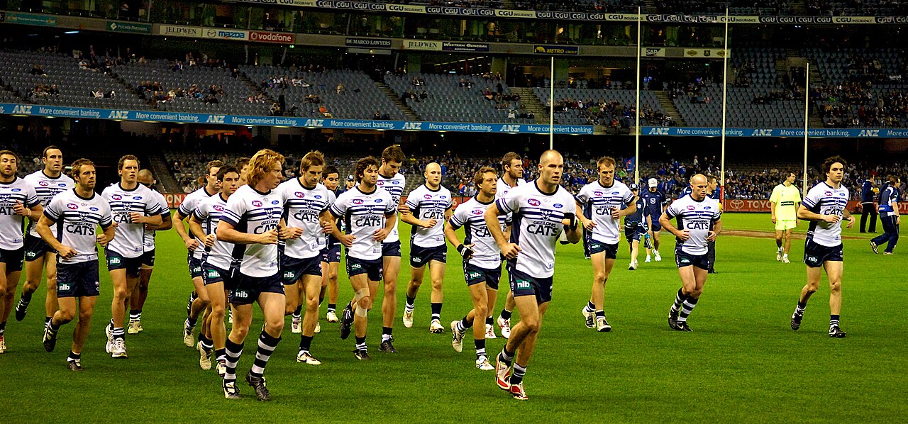 Football players warming up on a field