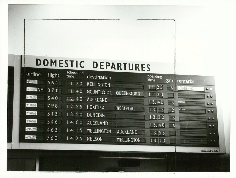 An airport departure board listing flights and destinations