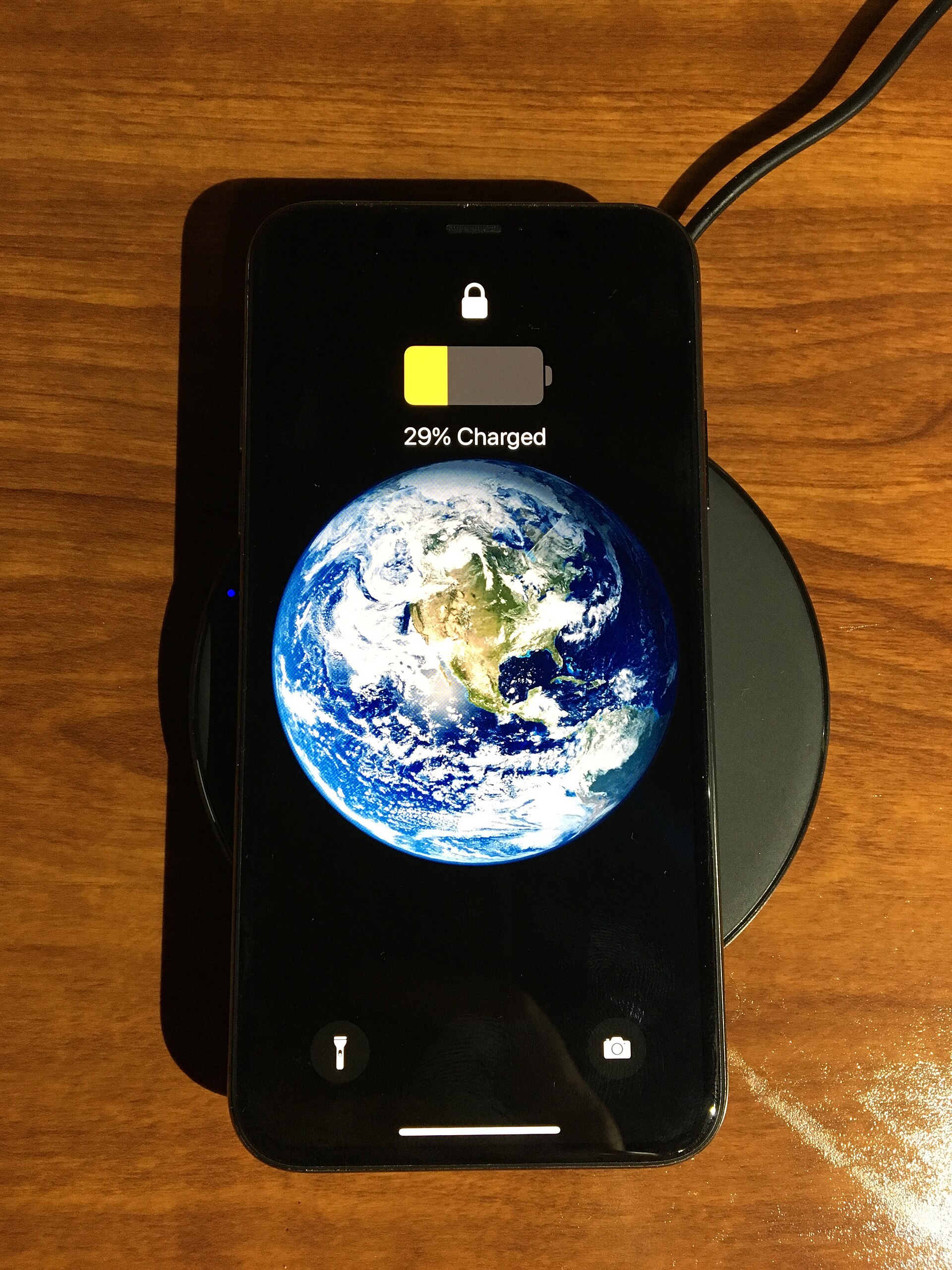 A phone resting on a wireless charging pad