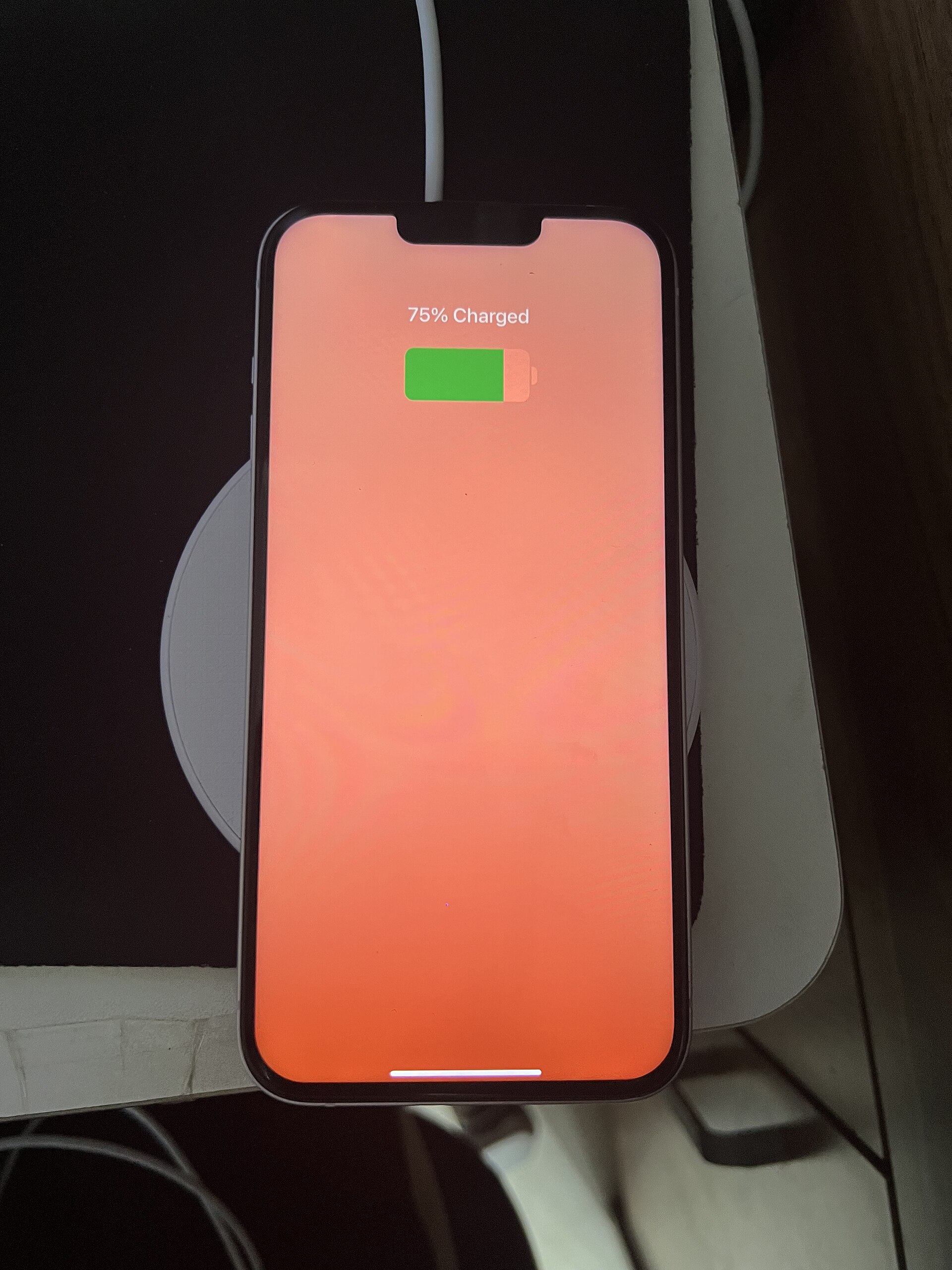 A wireless charger charging an iPhone