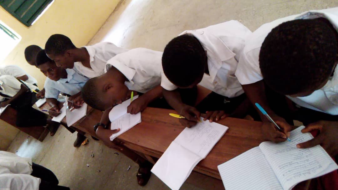 Students writing notes