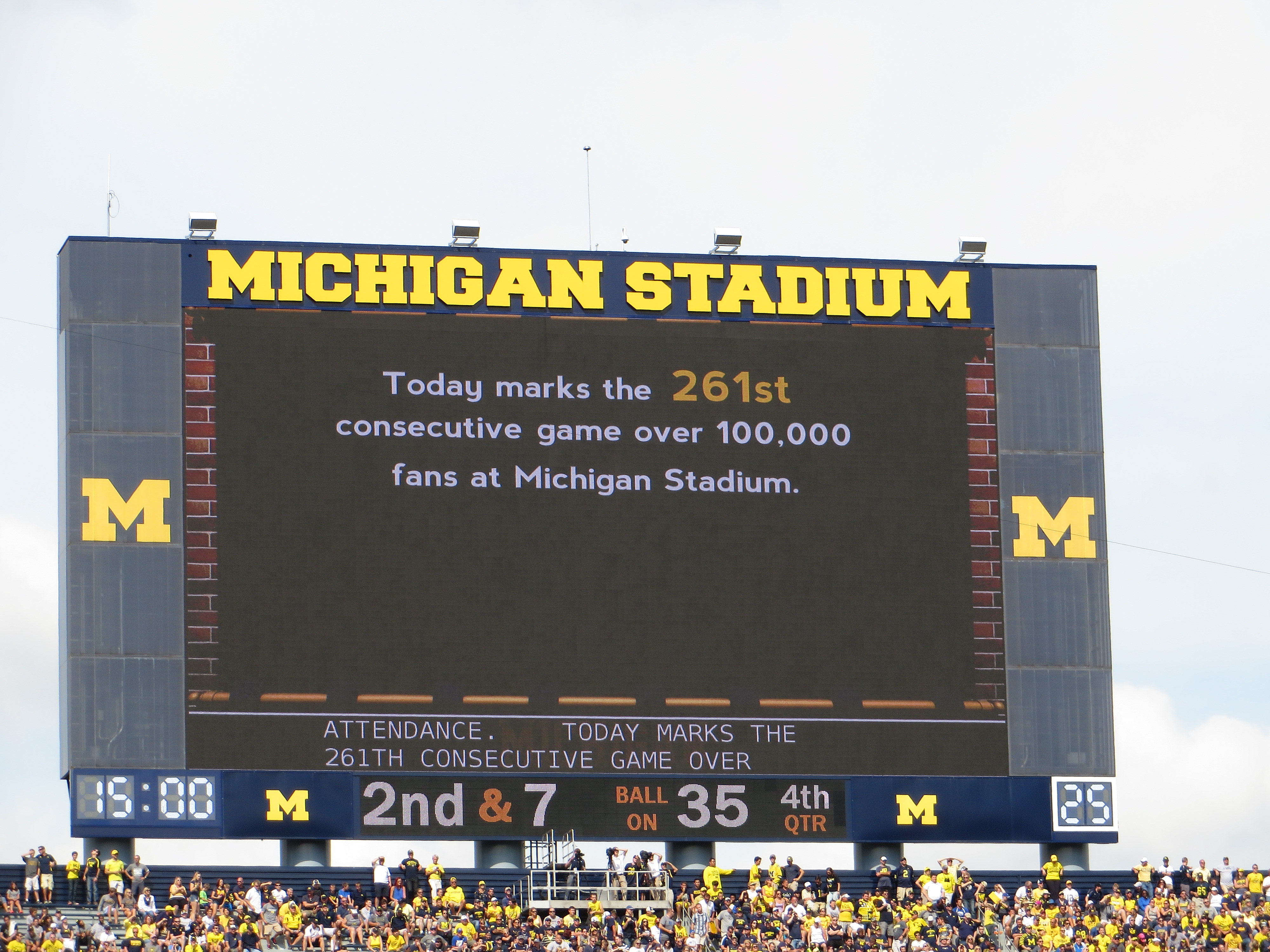 A large crowd fills a college football stadium on game day