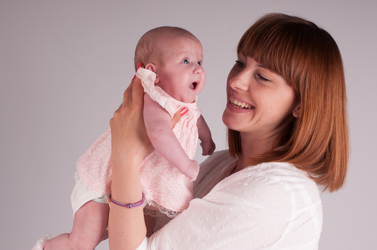 A mother holding her newborn baby close