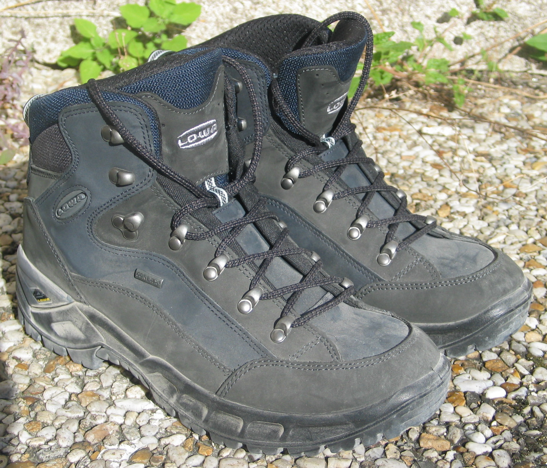 A pair of Lowa hiking shoes on a plain background