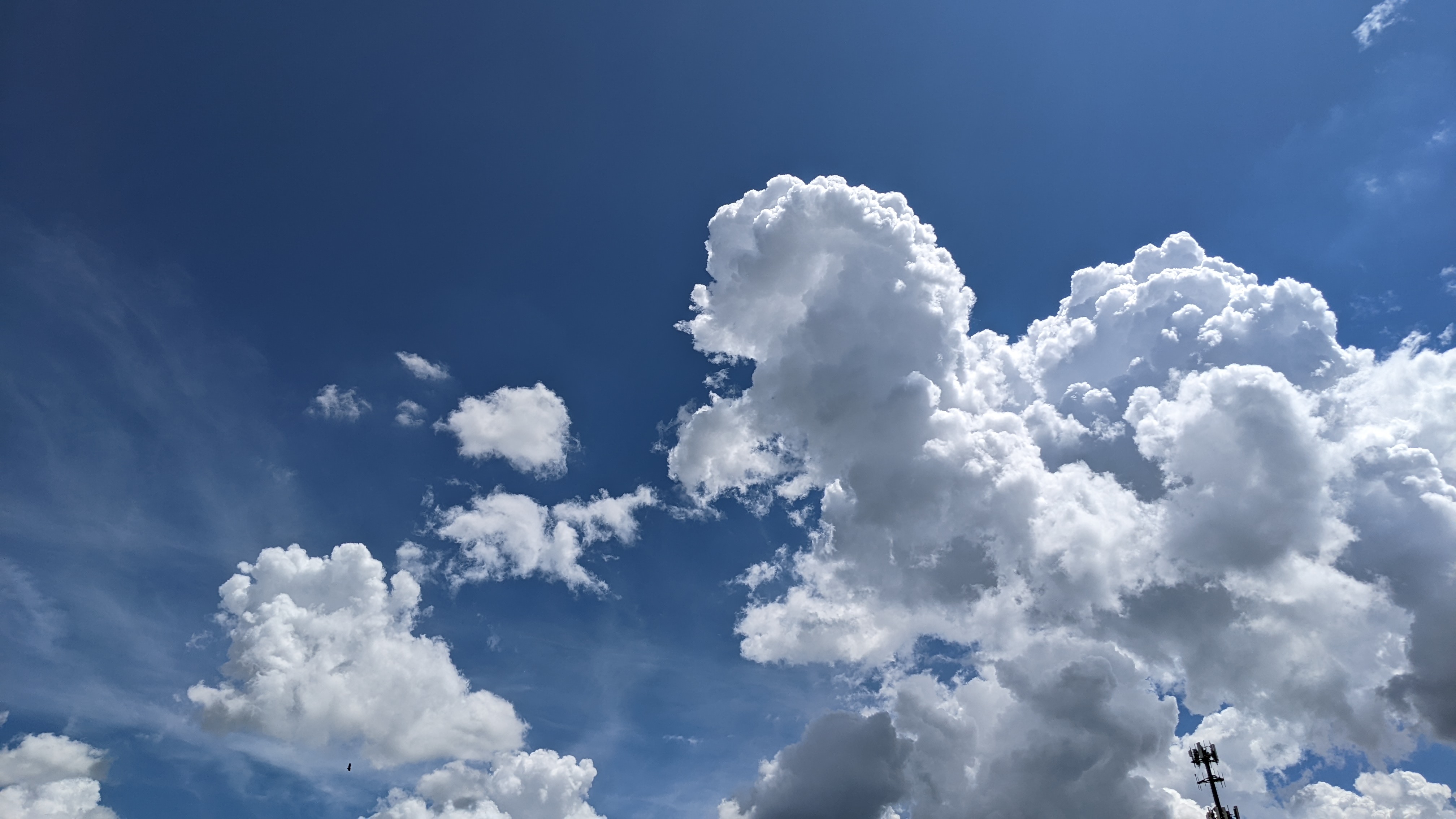 White cumulus clouds floating in a blue sky
