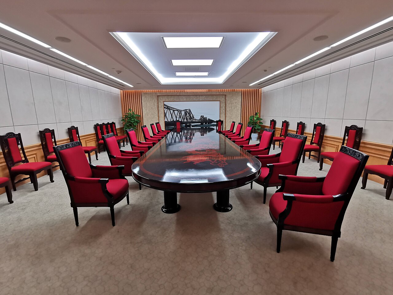 A meeting room with a long table and chairs