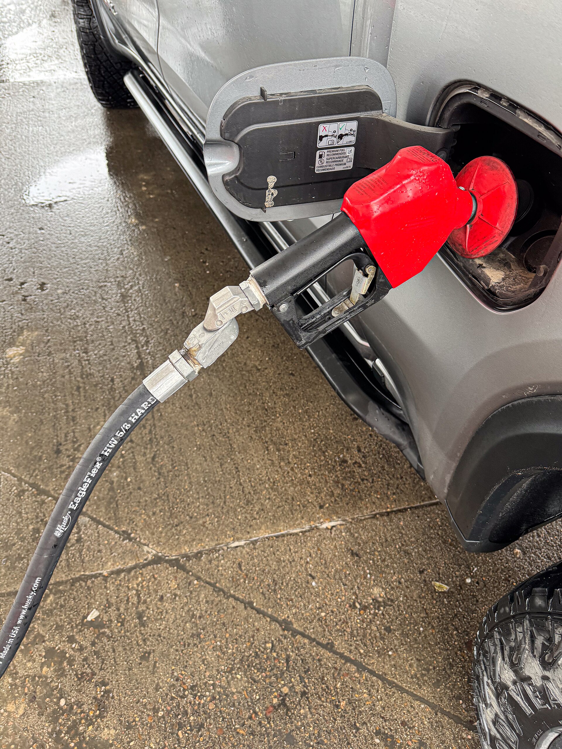 A fuel nozzle inserted into a car fuel filler