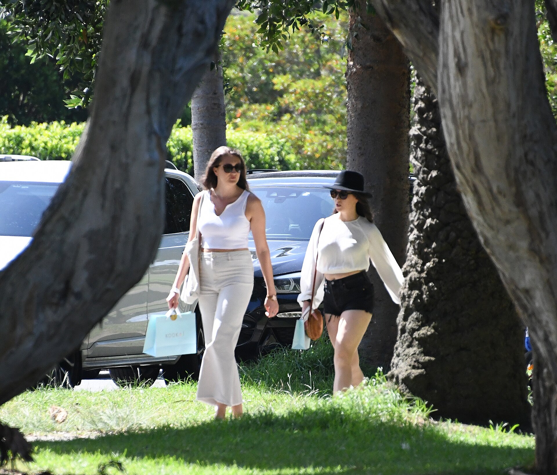 Two women walking together in a park