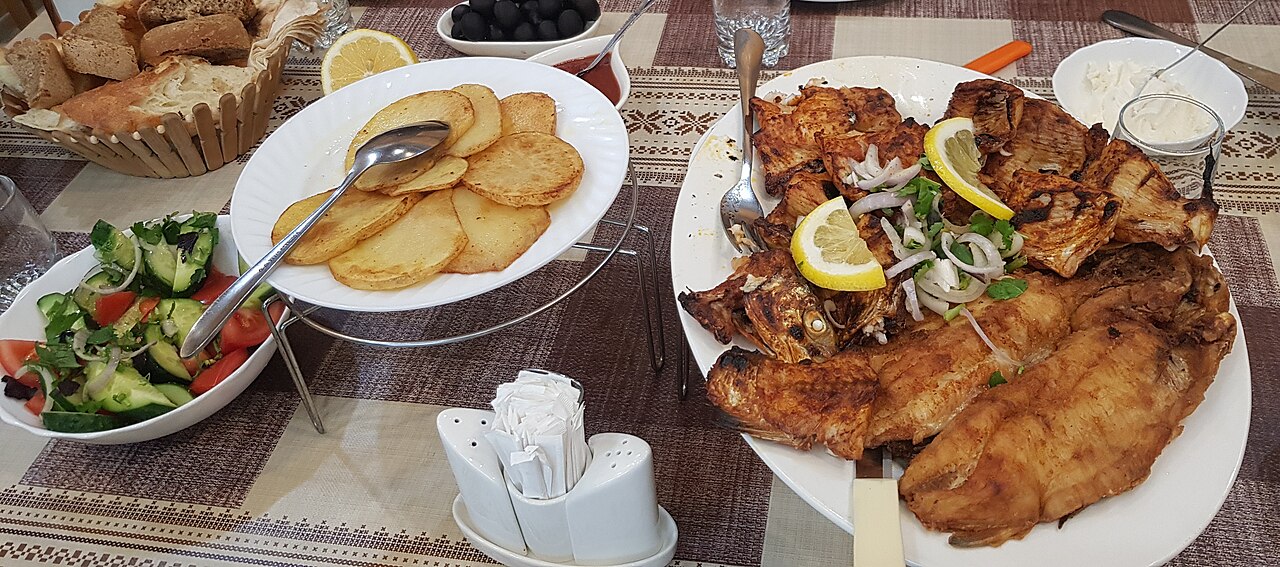 A dinner table set with a large shared meal