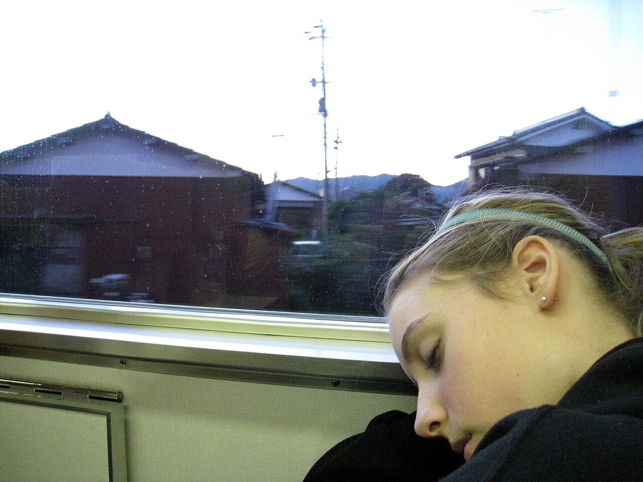 A person sleeping on a train after a long day