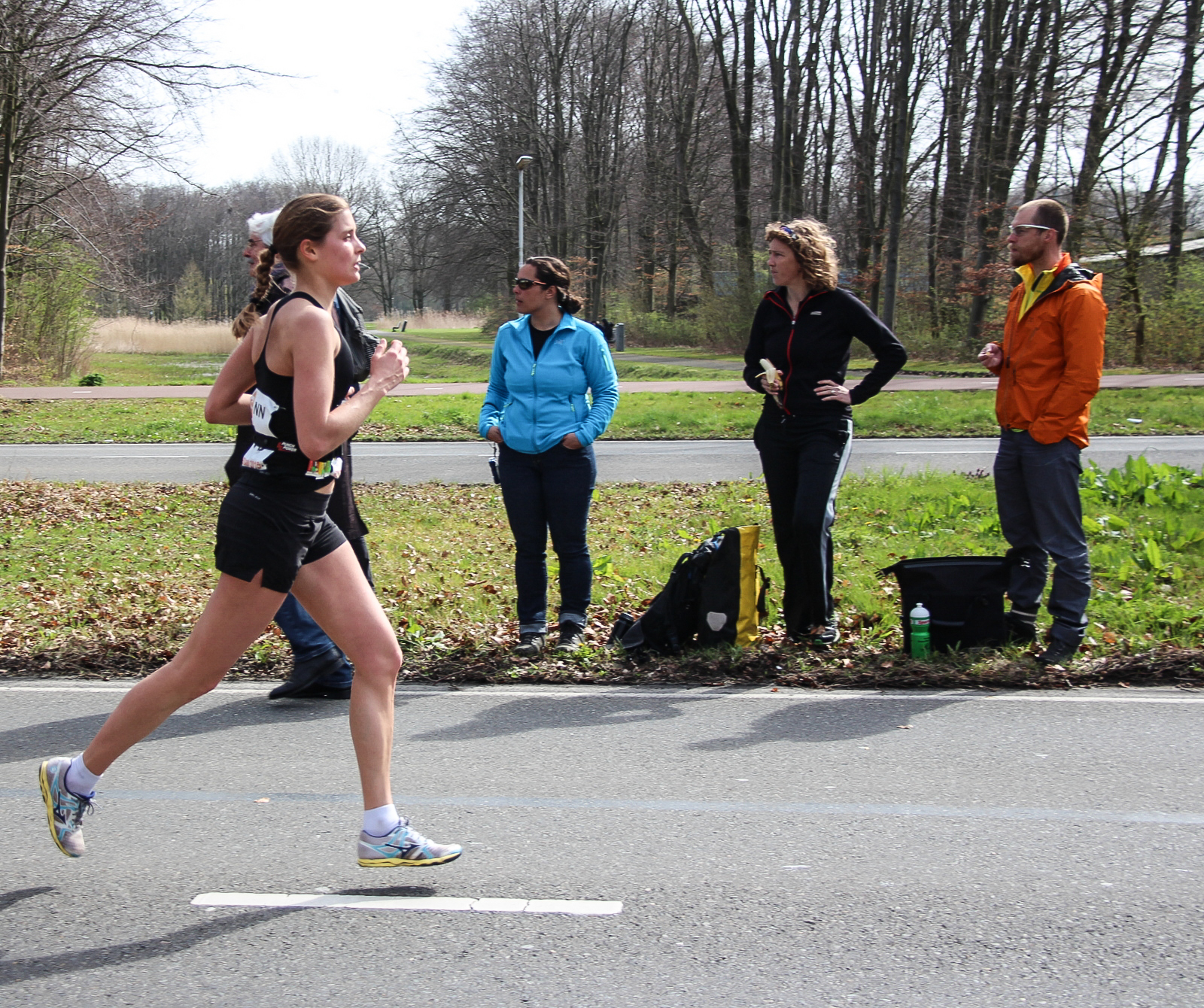 A runner on a road during a marathon, mid-stride