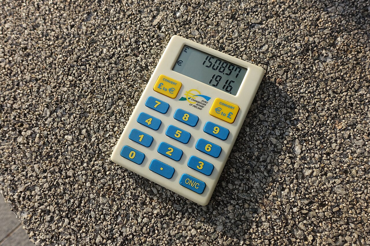 A small currency-conversion calculator on a stone surface