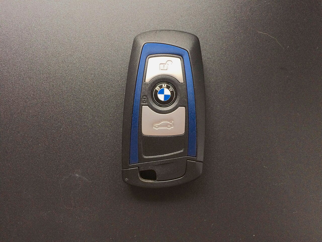 A BMW key fob with lock, unlock, and trunk buttons