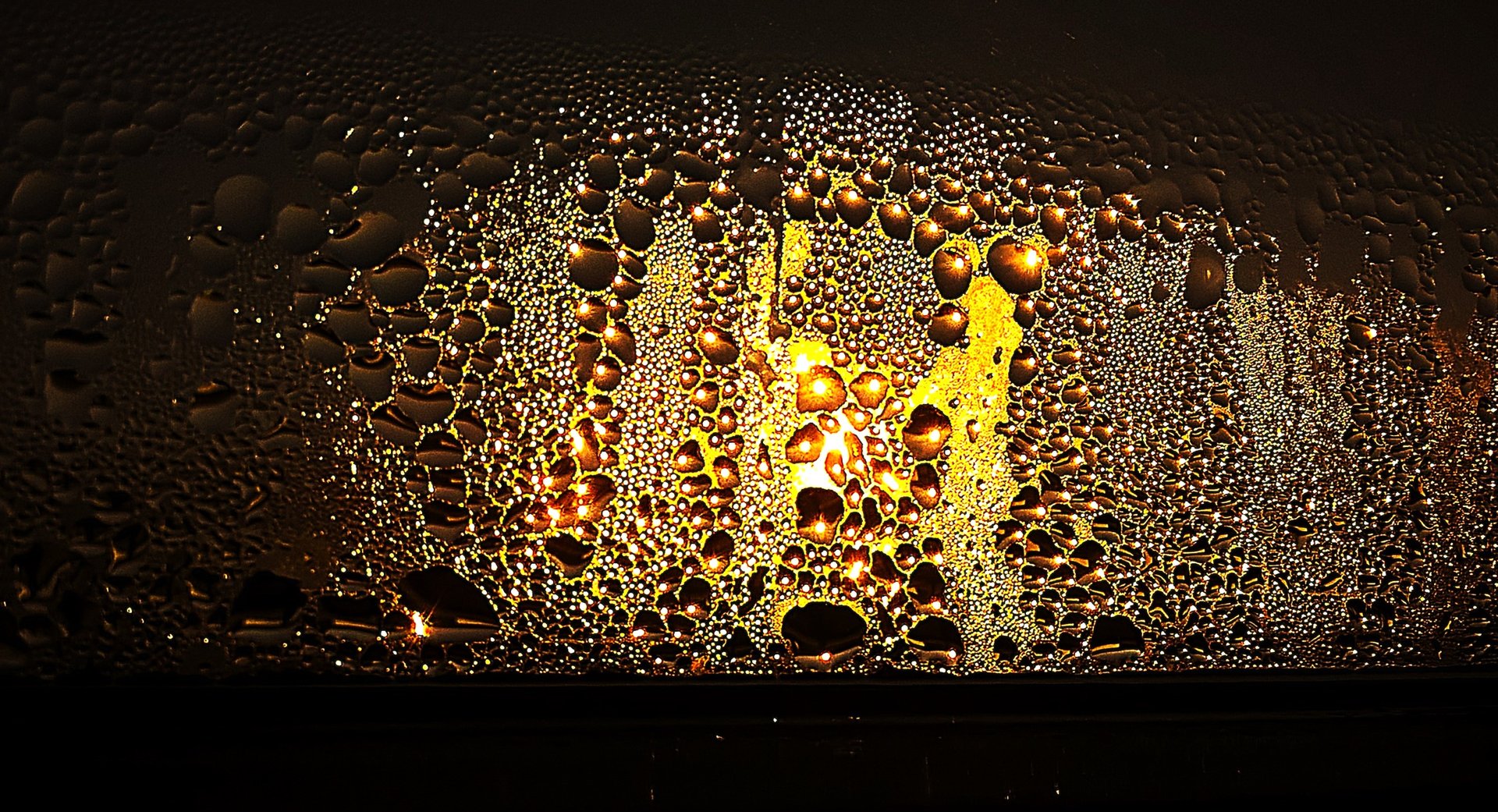 Water droplets covering the inside of a window on a cold day