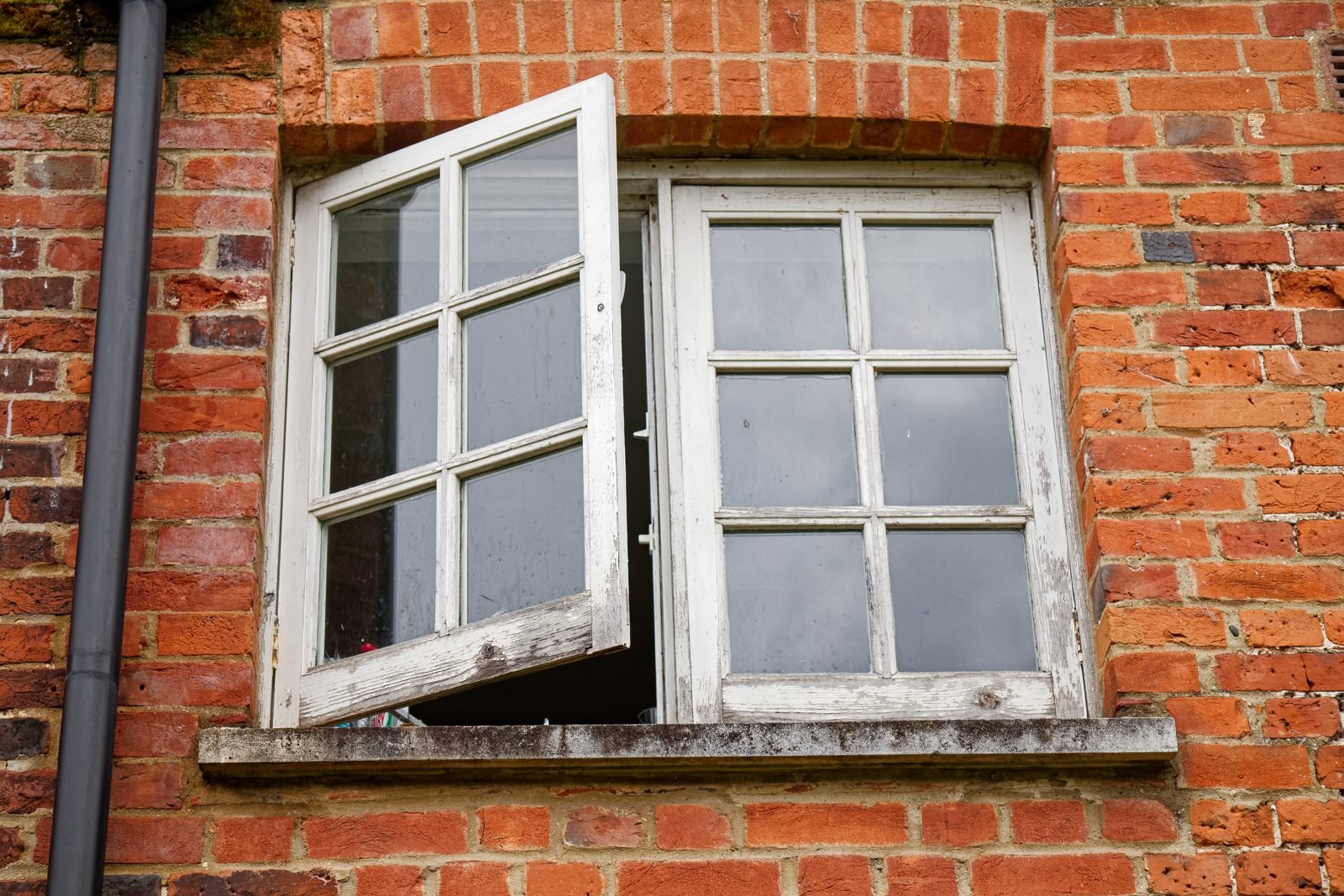 A window opened wide to let fresh air into a room