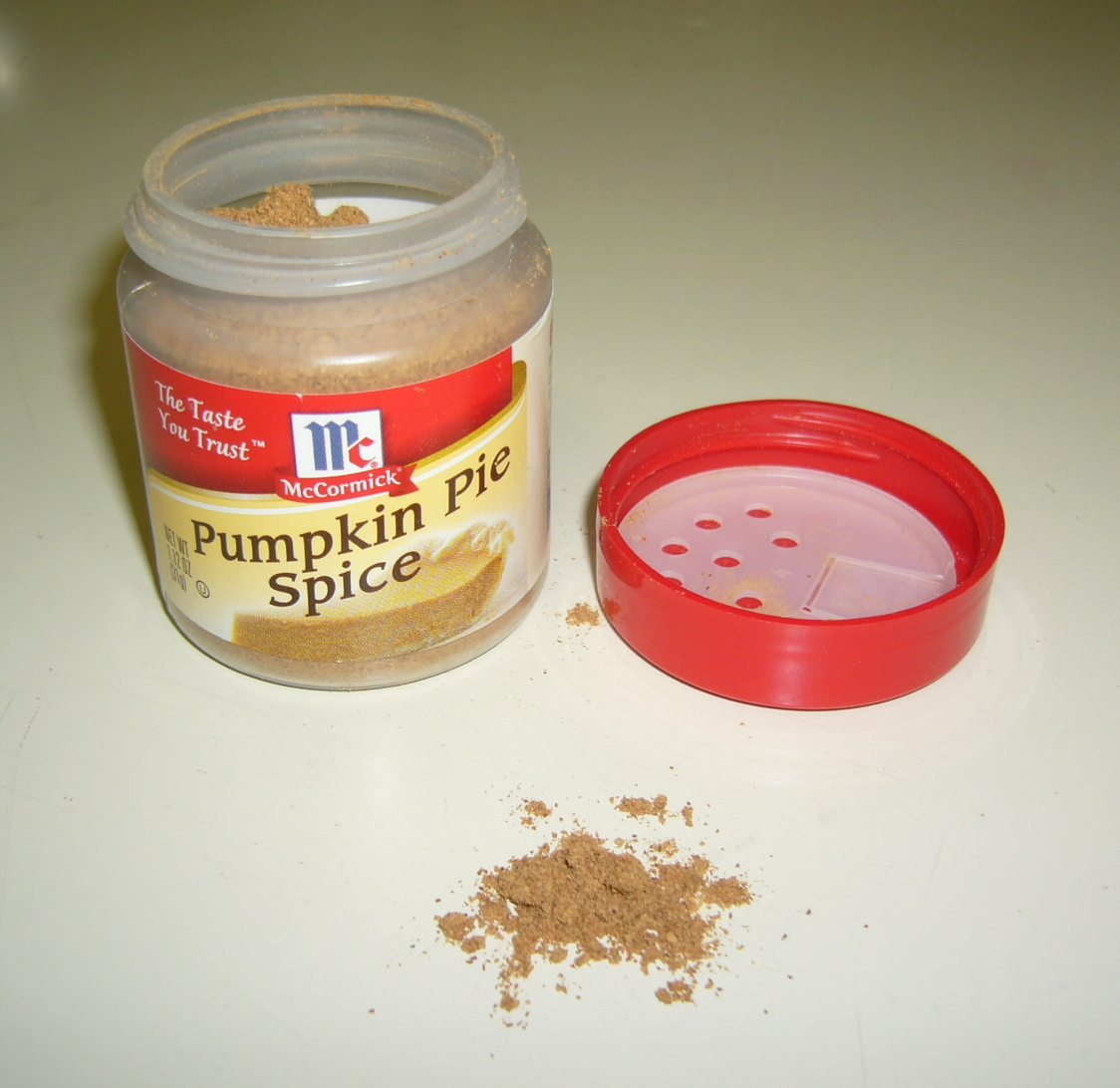 A jar of pumpkin pie spice blend with its lid on