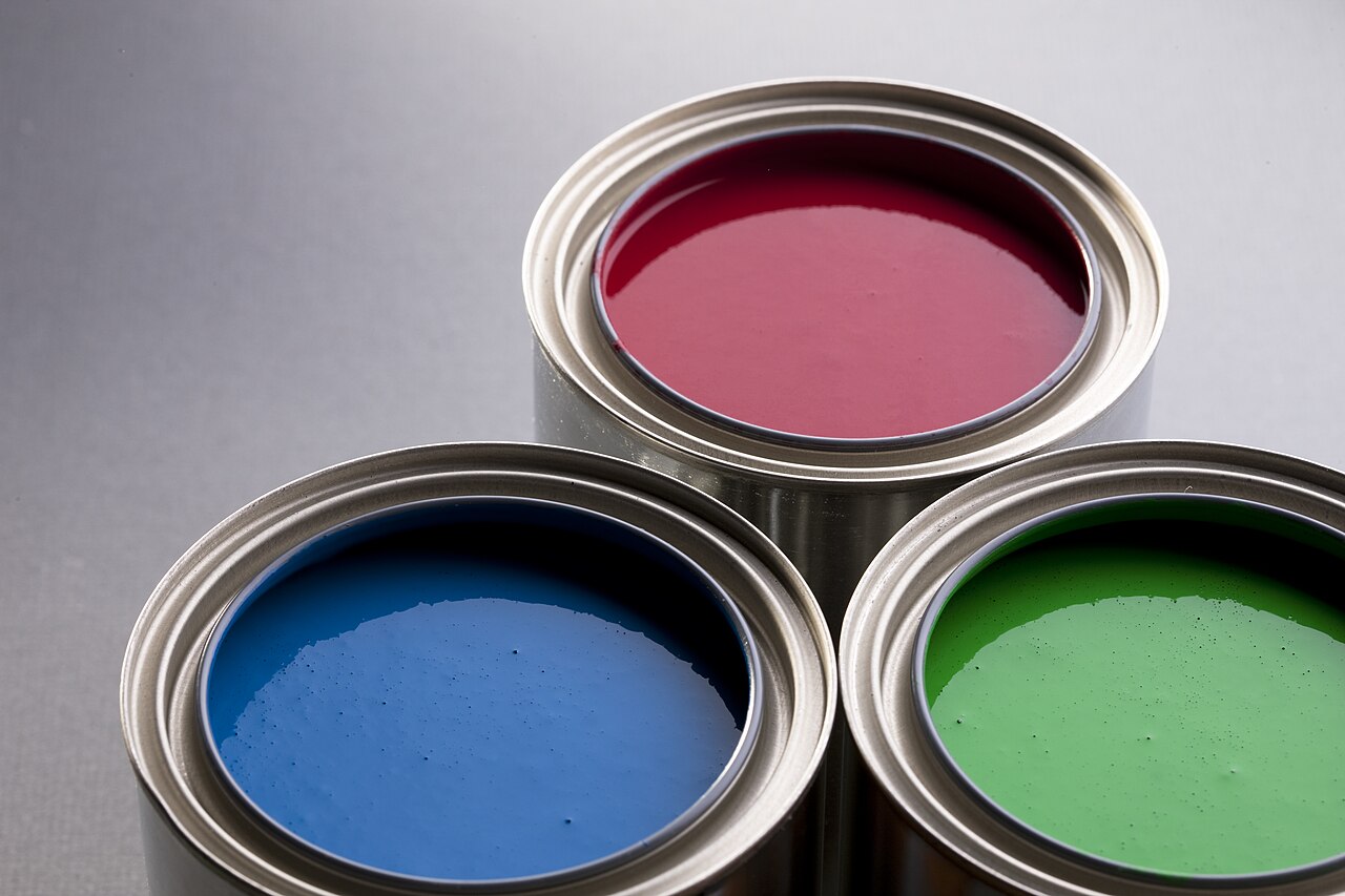 Open paint cans waiting to be sealed for storage