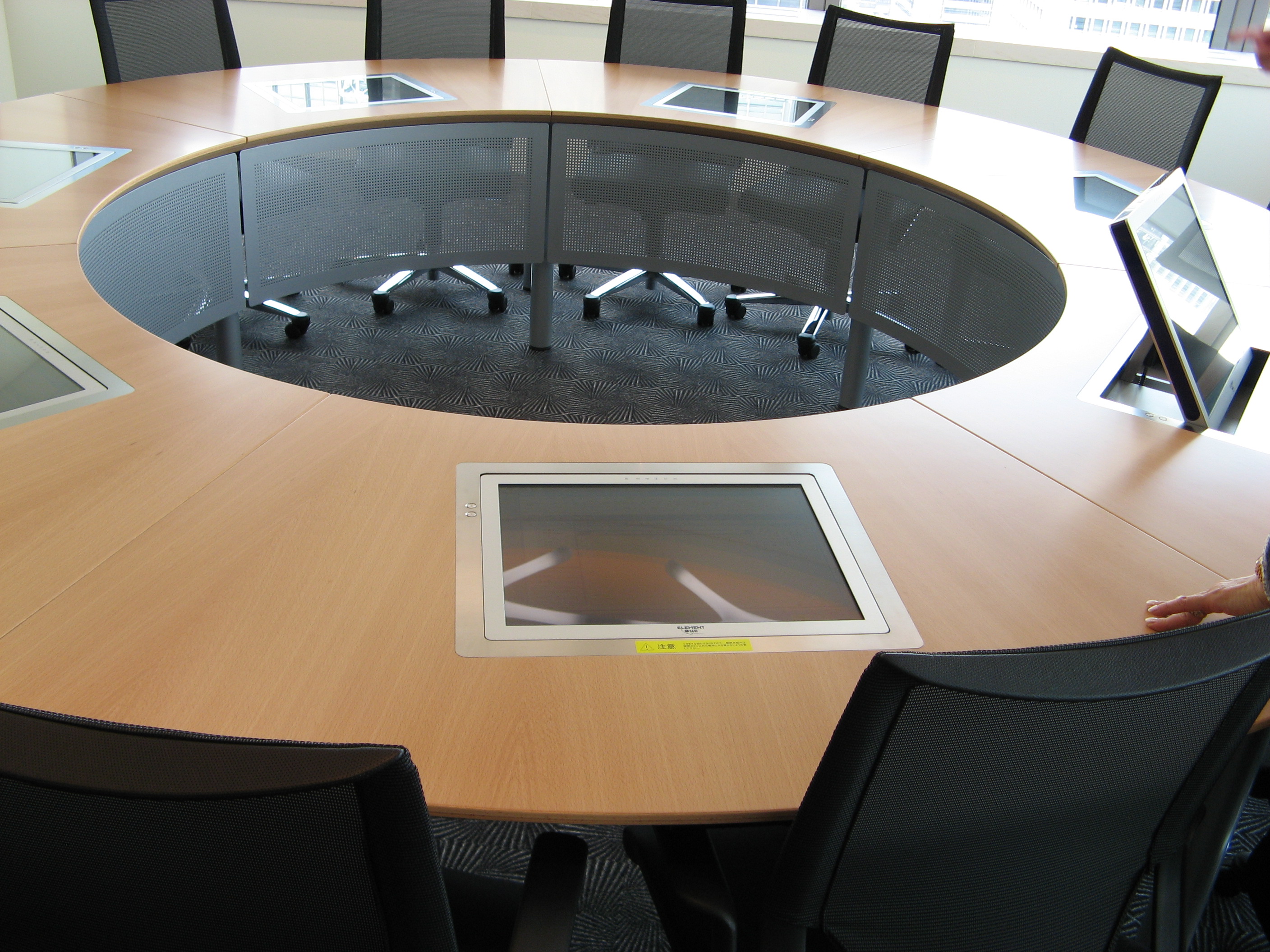 Colleagues gathered around a table in an office meeting