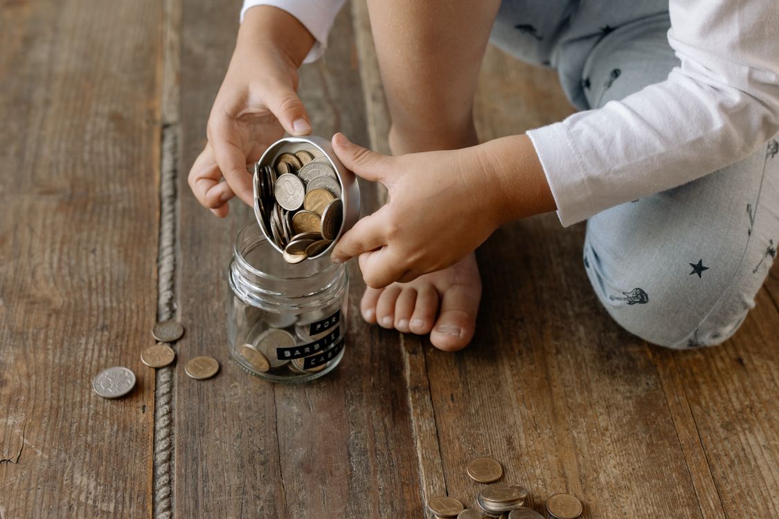 A child learning about coins and saving