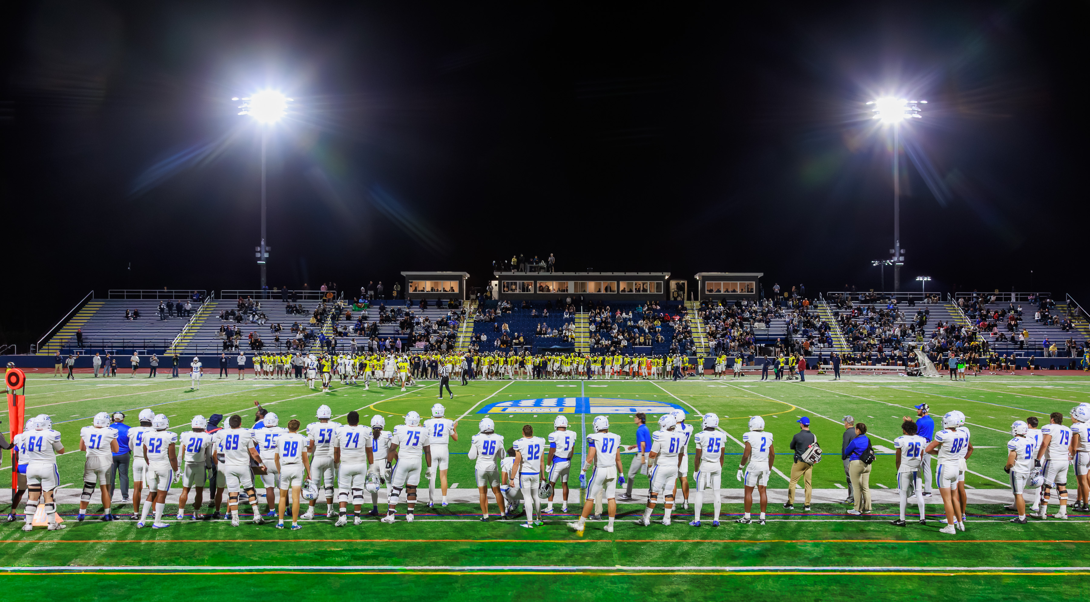 A college football game played under bright lights at night