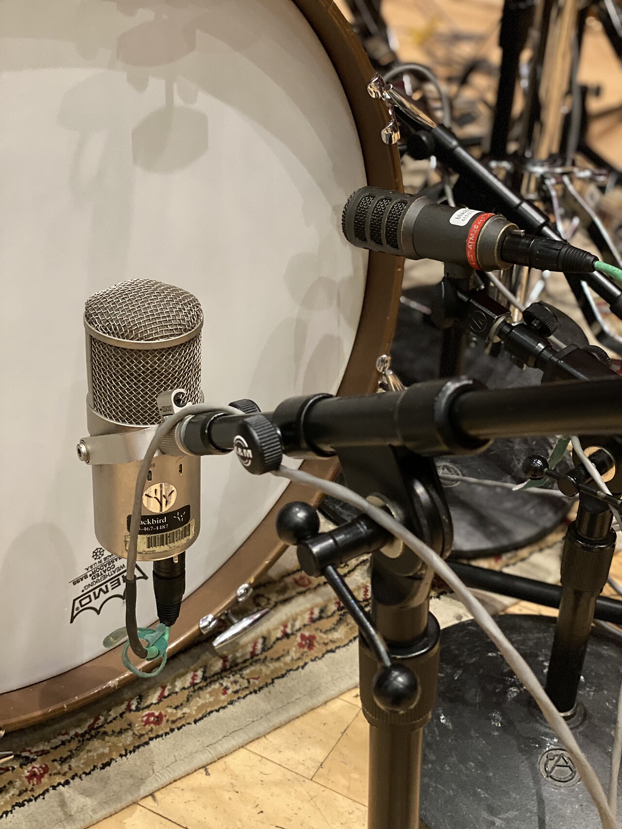 Microphones arranged around a drum kit in a recording studio