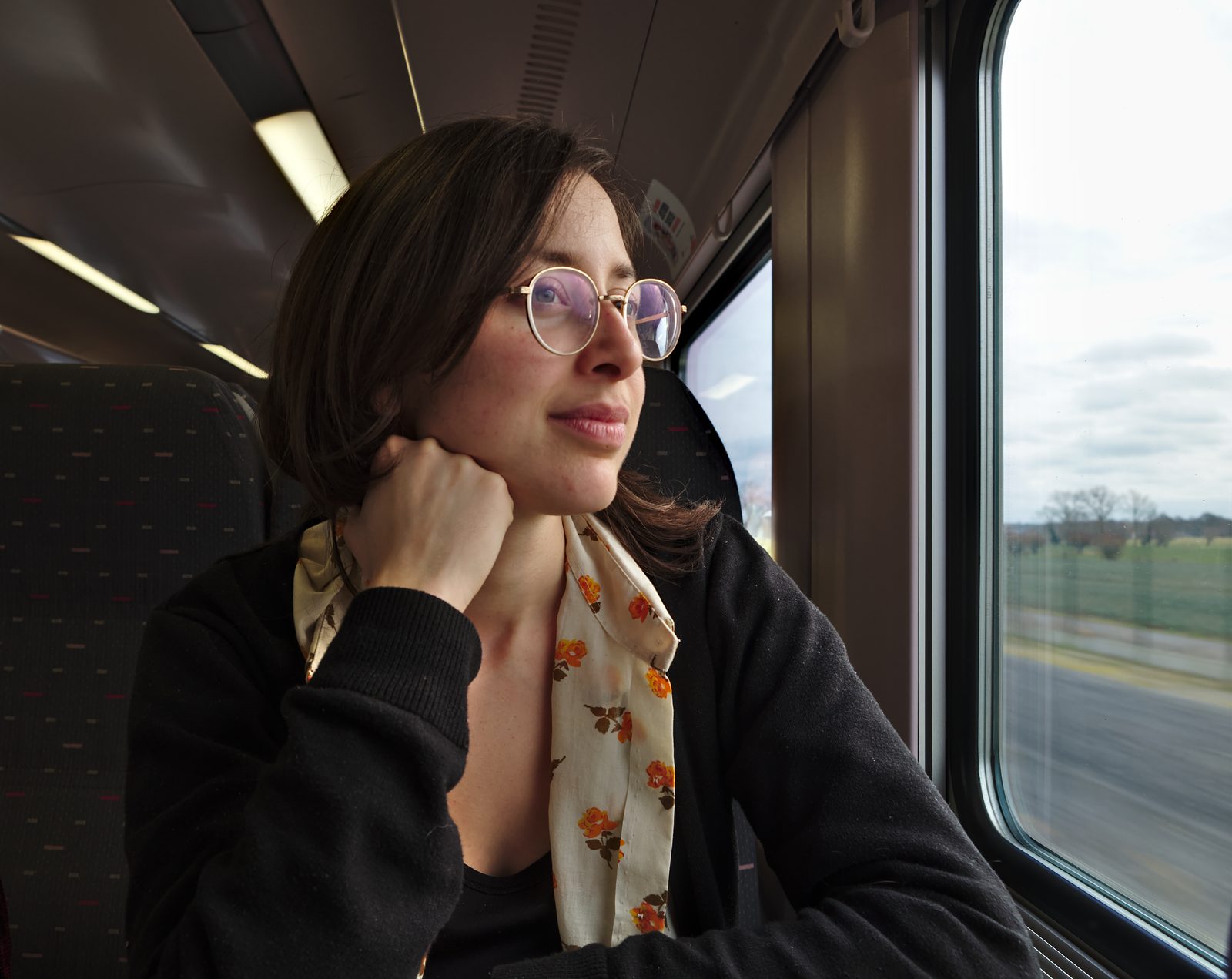 A passenger looking through the window of a train