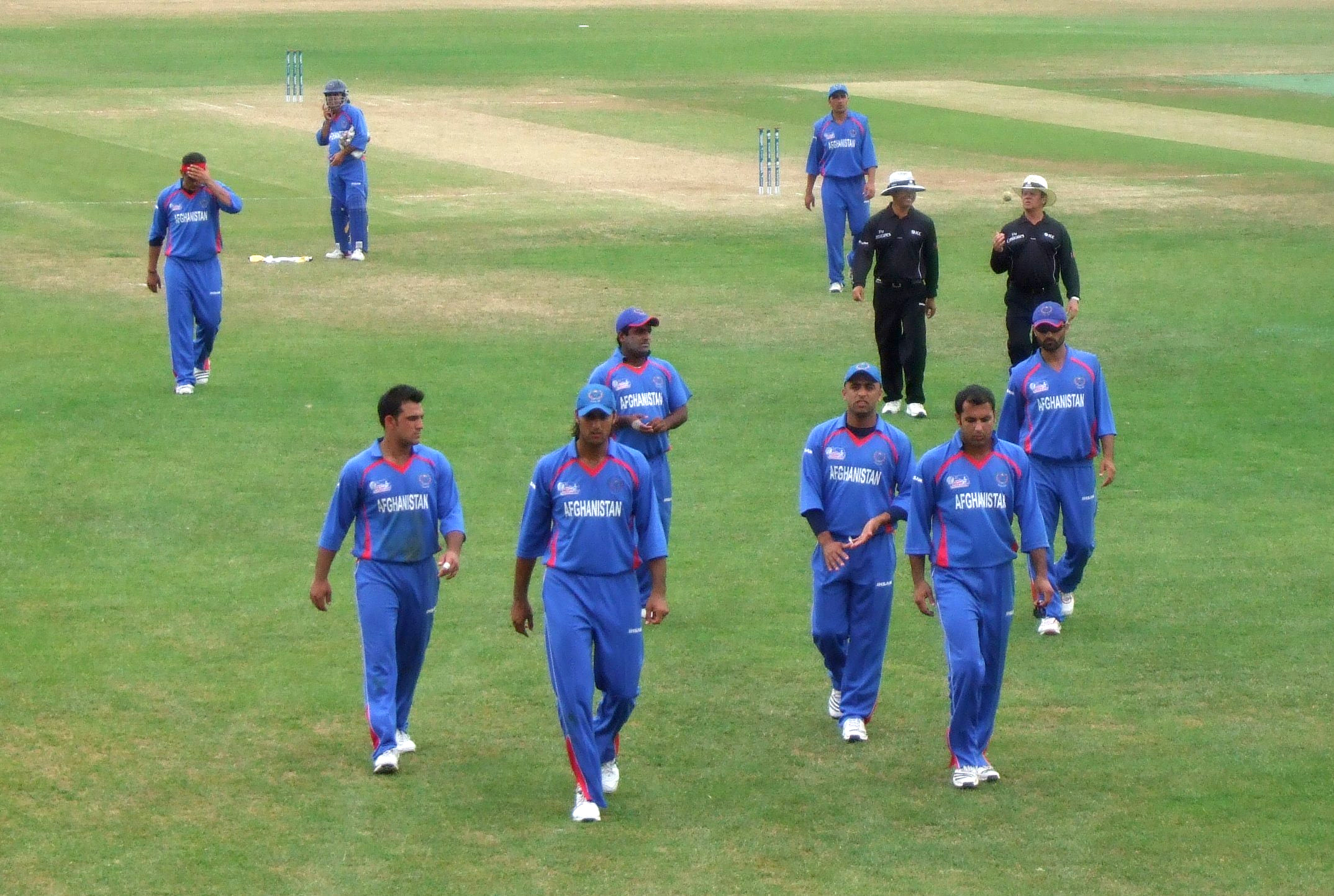 Afghanistan national cricket team players pose together on the field