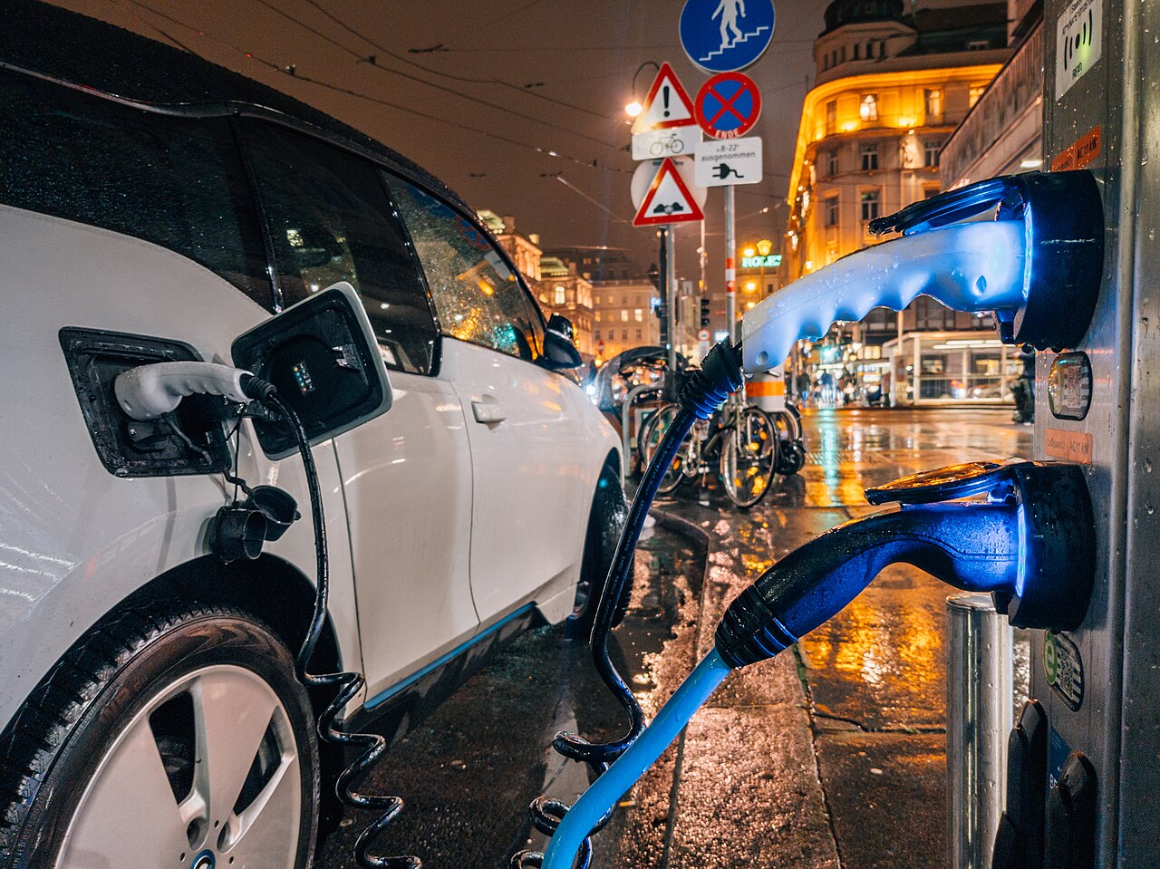 An electric car charging at night