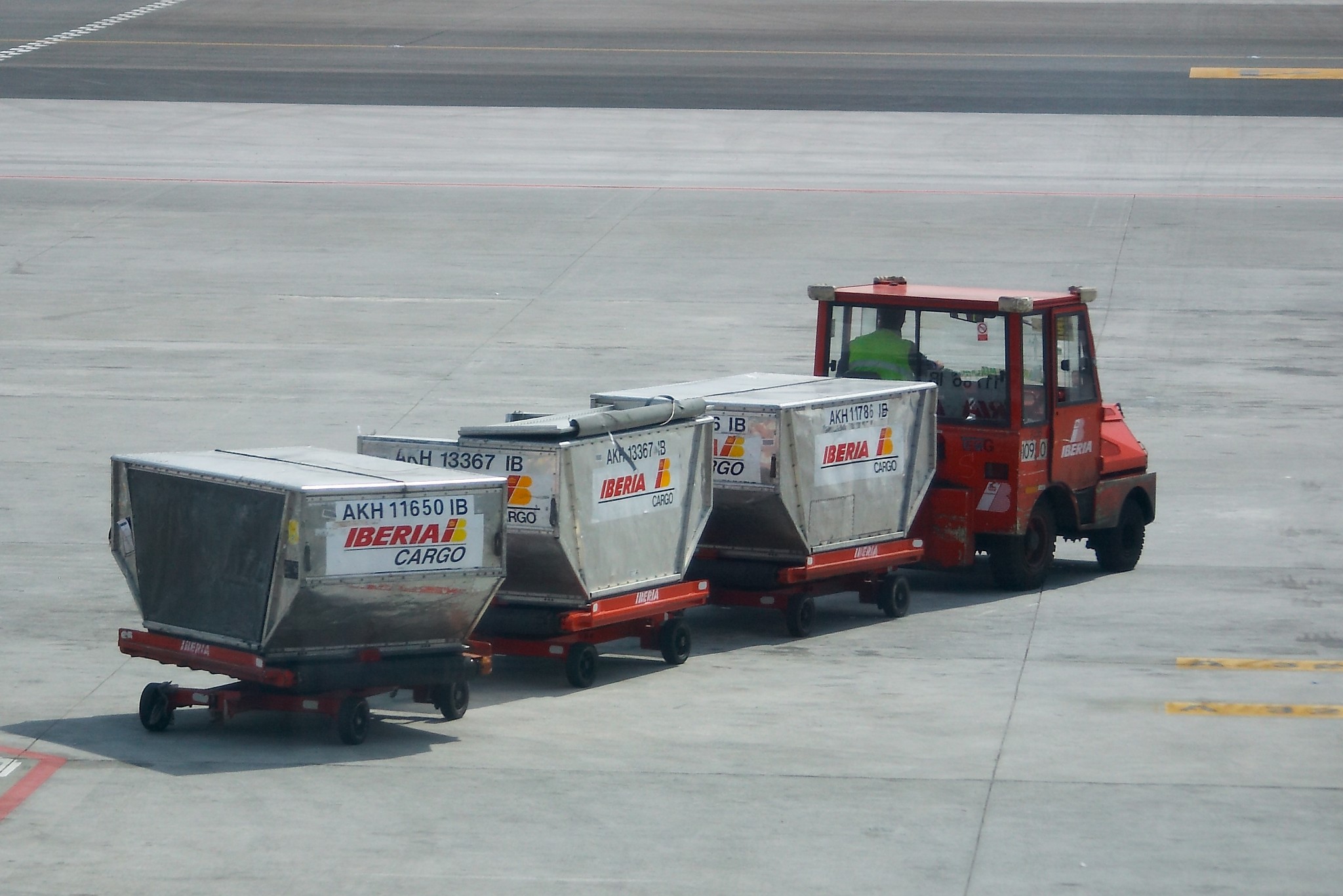 Bags on a luggage cart at an airport