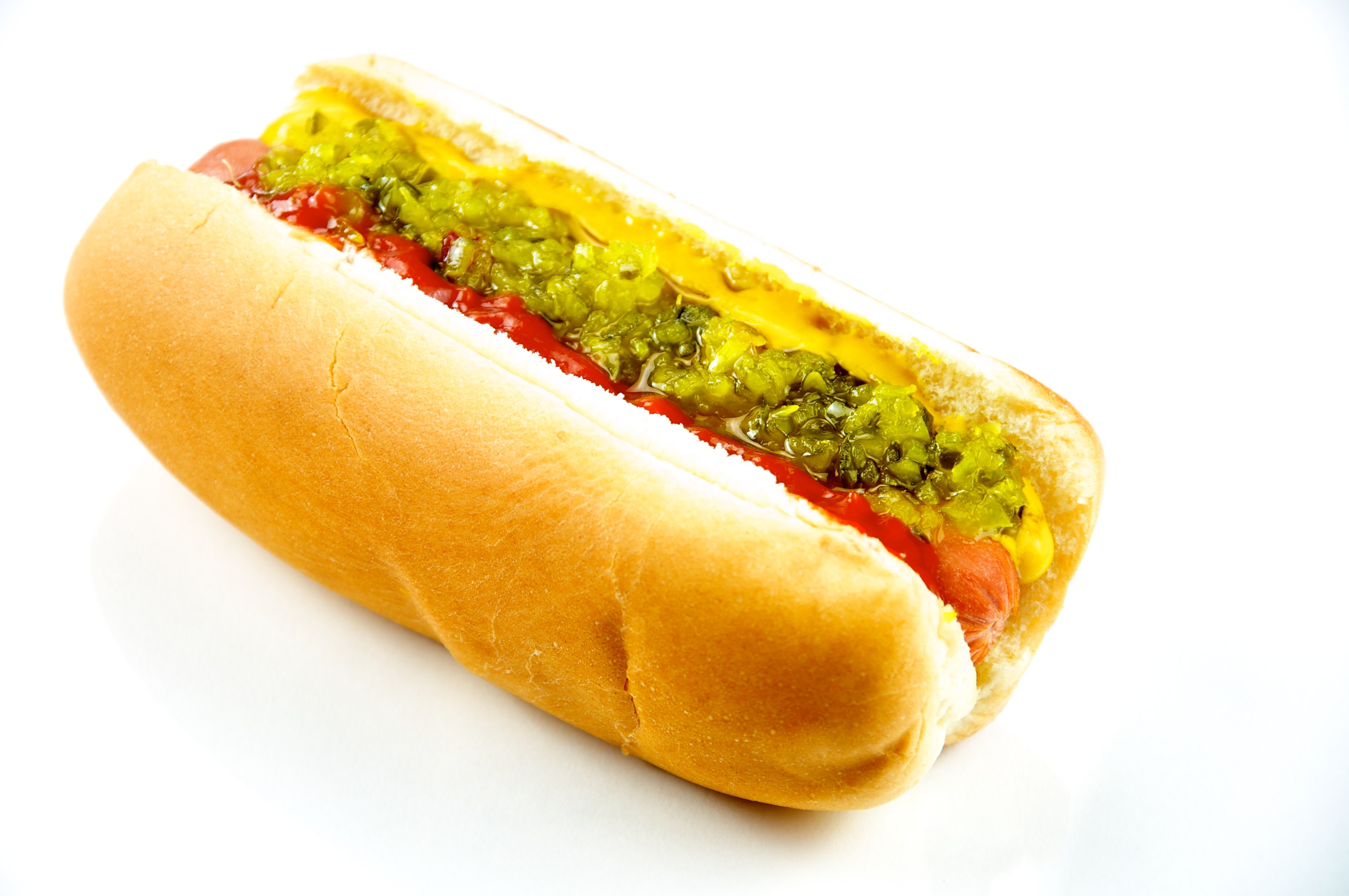 A hot dog with toppings on a plate