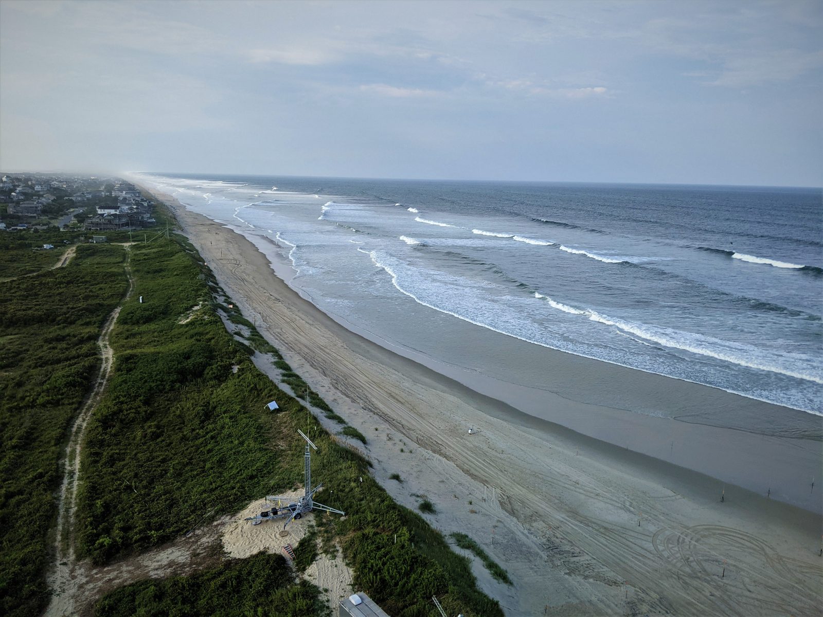 The Outer Banks coastline from above, with thin barrier islands between the ocean and the sound