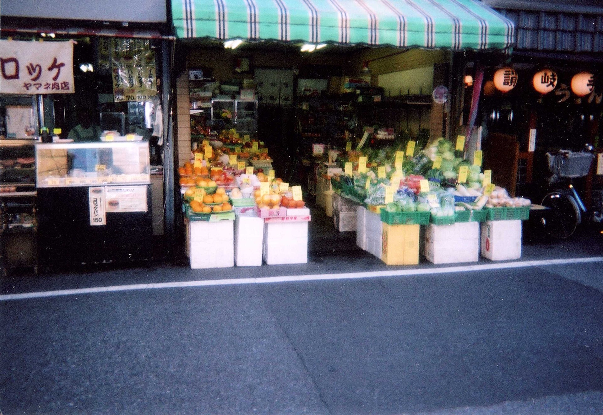 A vegetable stall at a market with fresh produce on display