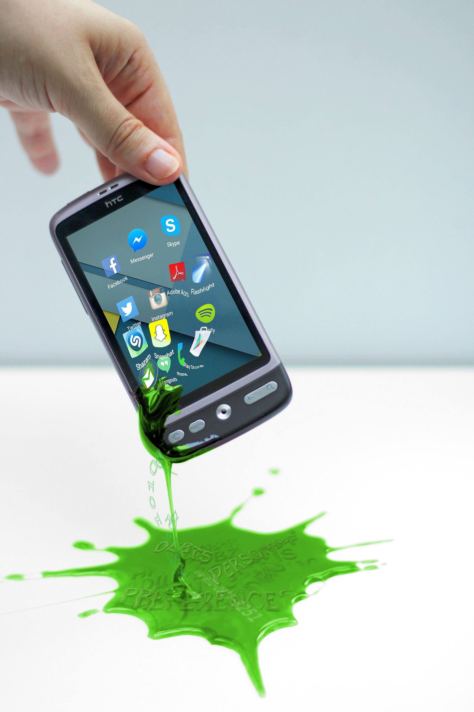 A hand holding a phone as app data spills out as liquid