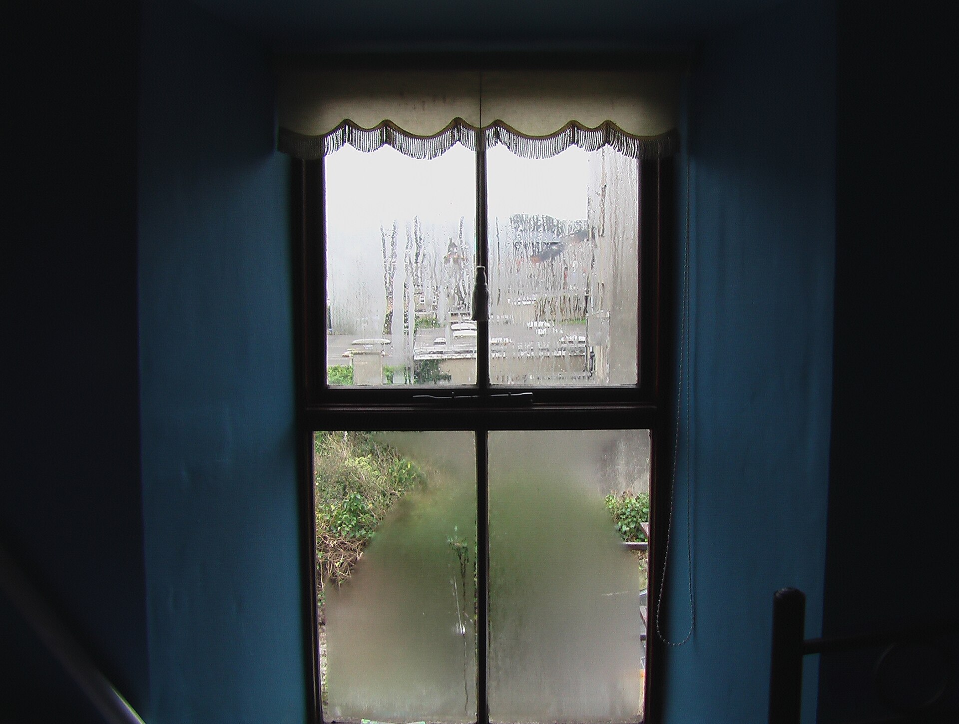 A window with condensation droplets on the glass