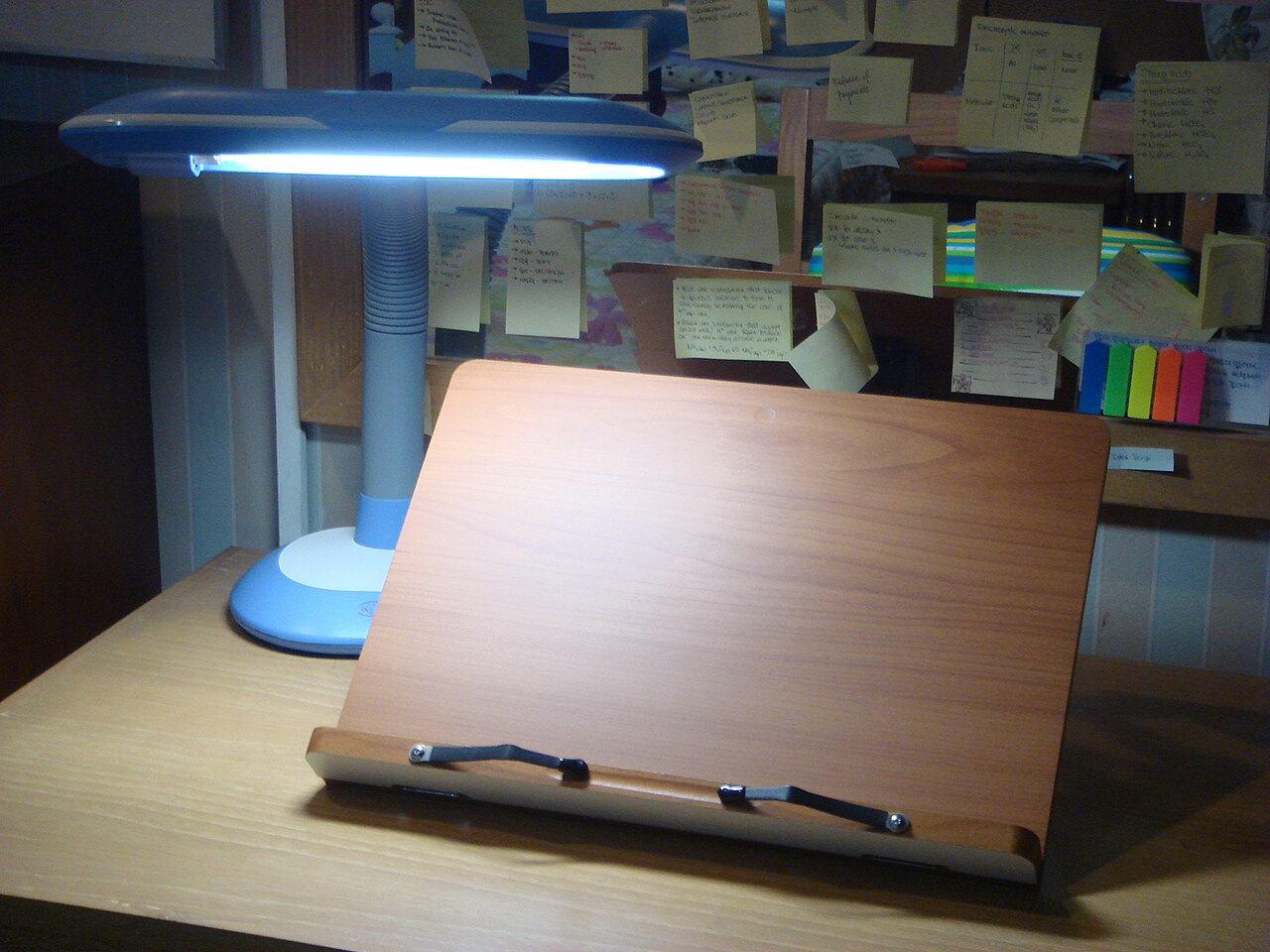 A bookstand with a desk lamp on a study desk