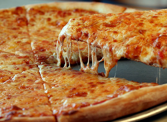 A cheese pizza with melted cheese, showing the bubbly top a good reheat should restore