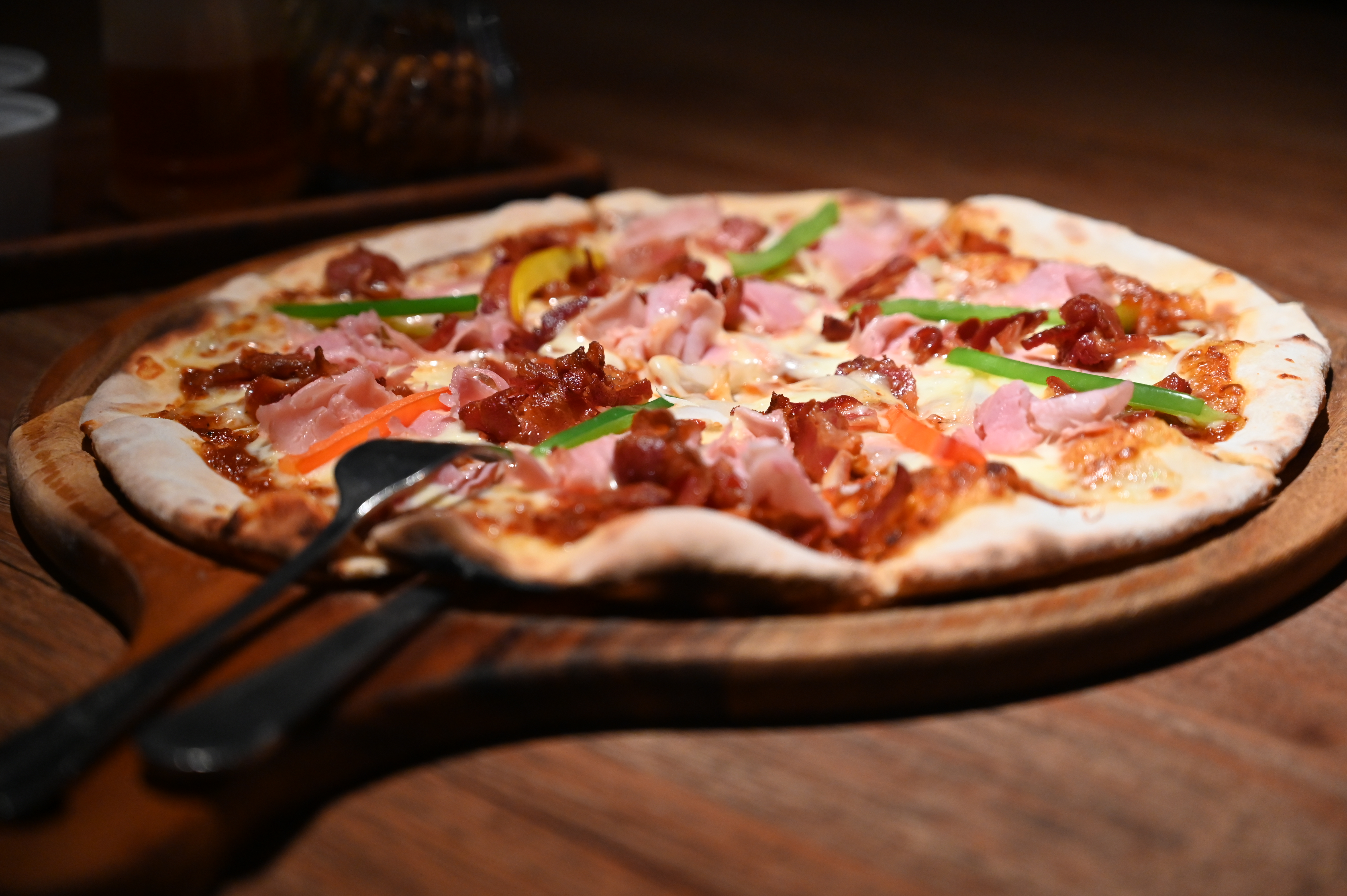 A wood-fired pizza ready to slice, the style that reheats especially well on a hot steel