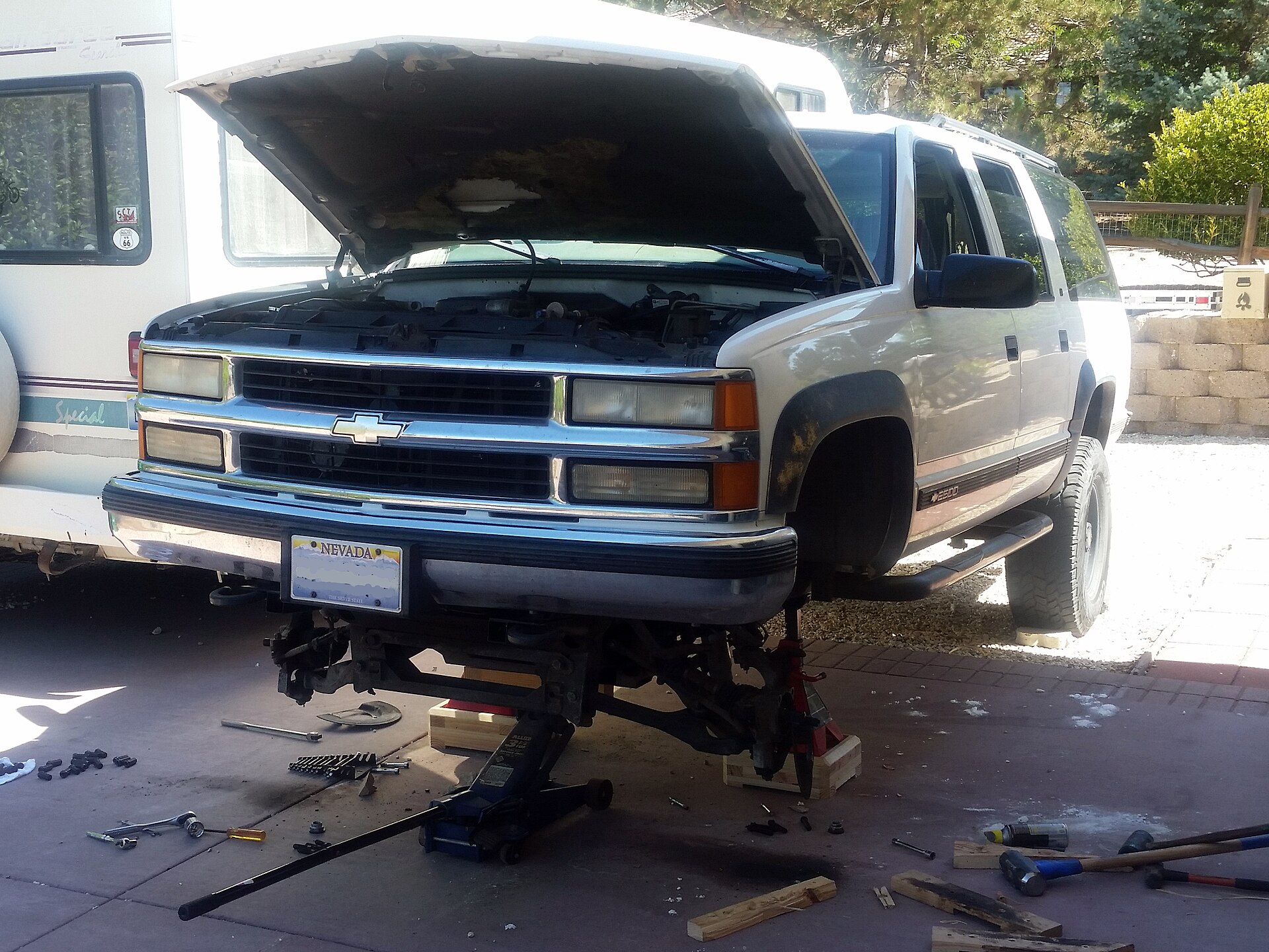 Car raised on a jack during brake work