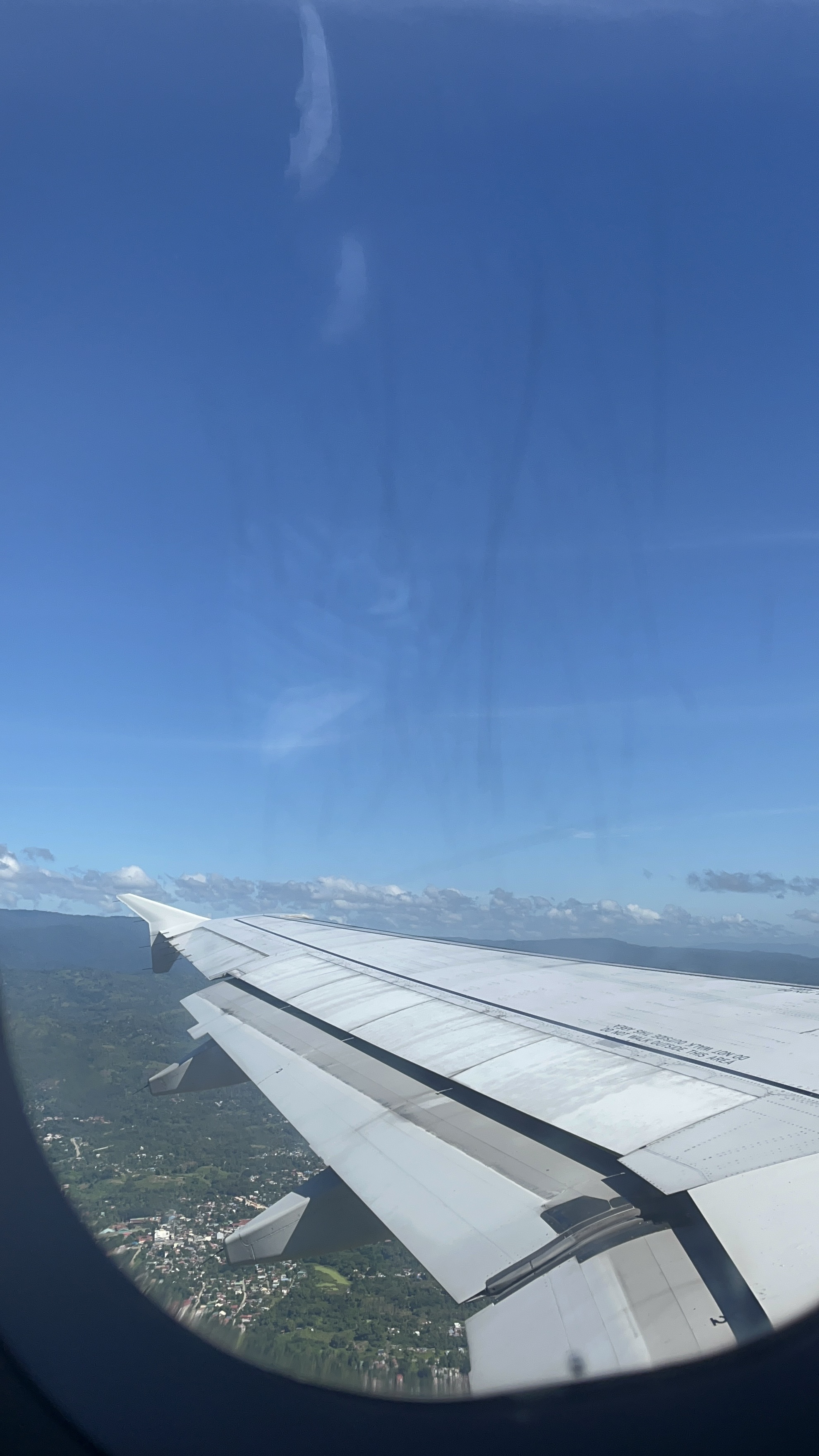 Clouds and sky seen from an airplane window during a flight