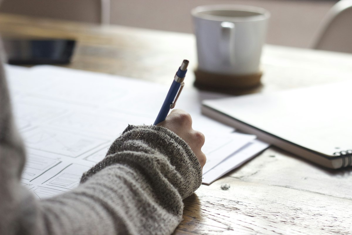 Candidate writing in a notebook while waiting to hear back after an interview