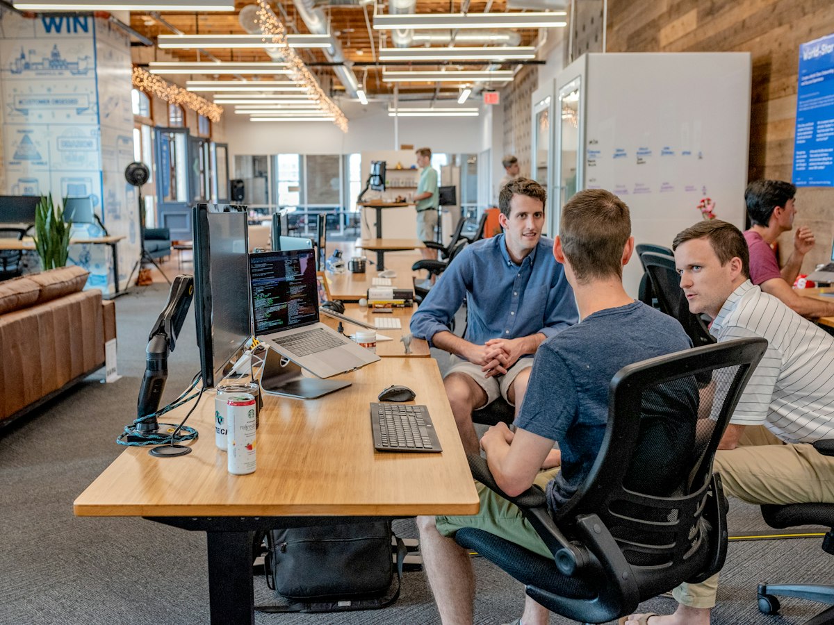 Hiring team in a meeting reviewing candidates and interview notes