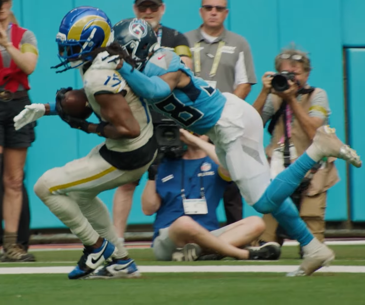 Davante Adams in a Rams uniform runs with the ball against the Titans
