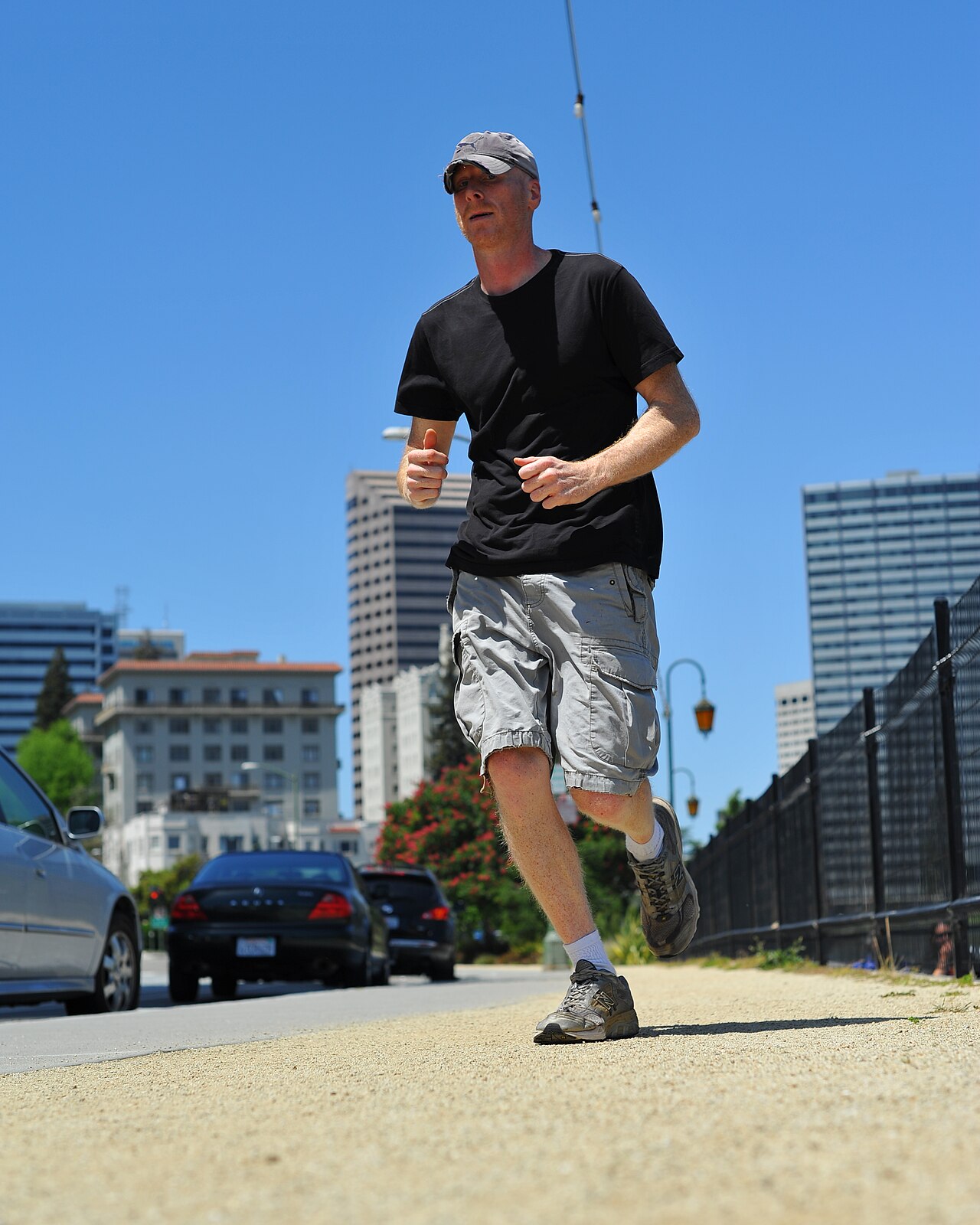 A jogger running on a road in running shoes