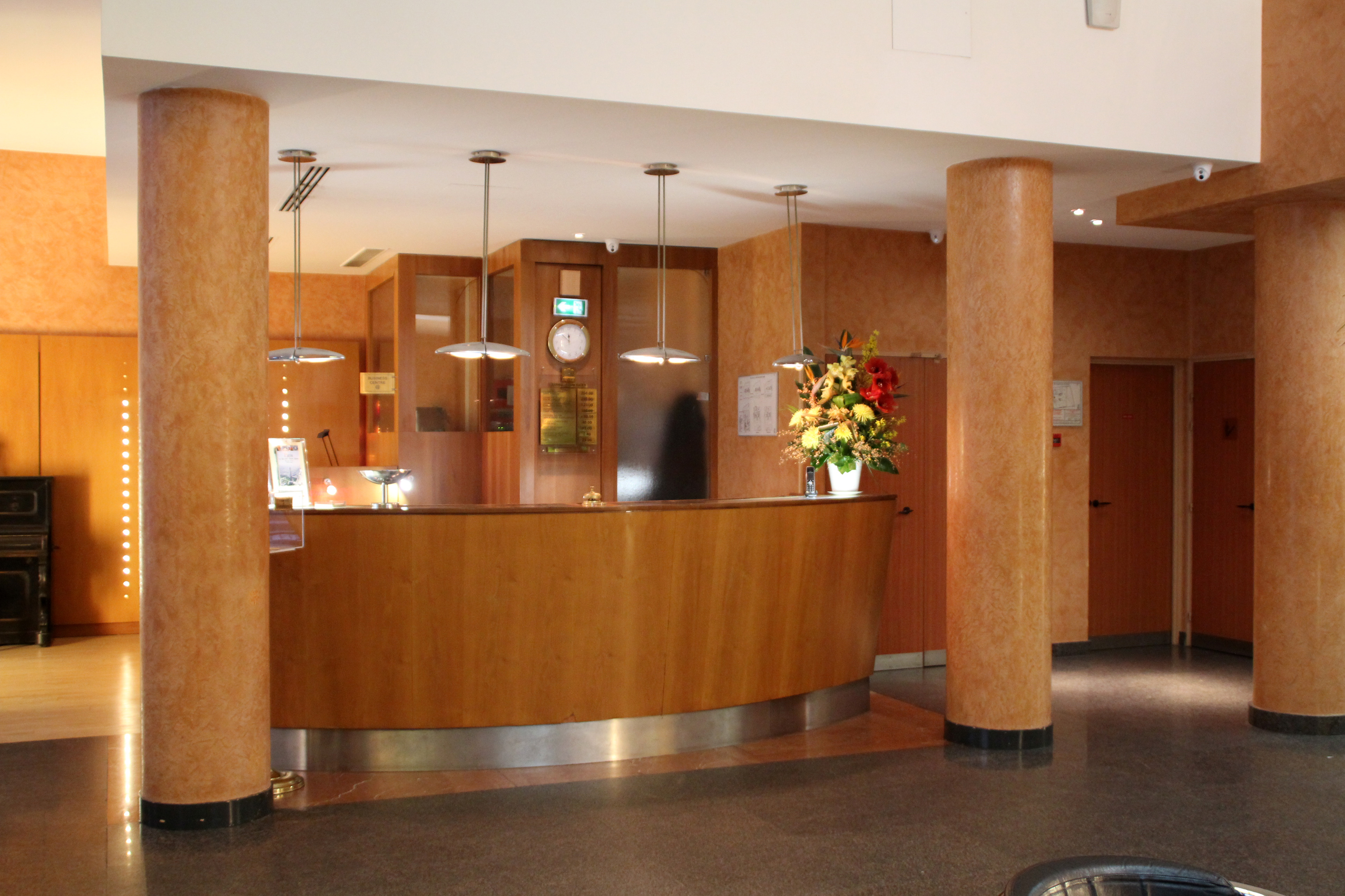 A hotel front desk where guests check in and provide a card for the incidental hold