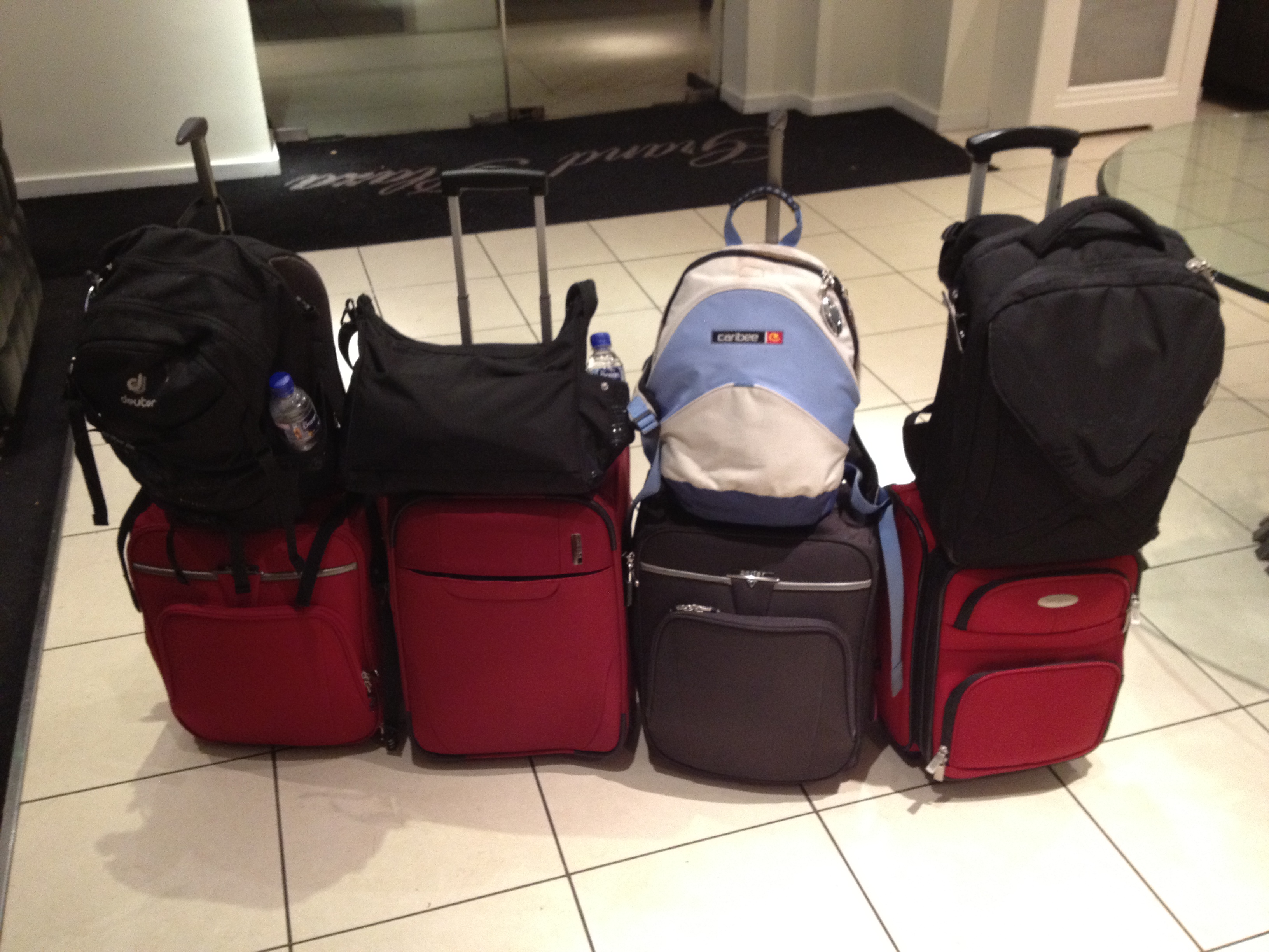 A pile of packed suitcases and travel bags ready for a trip