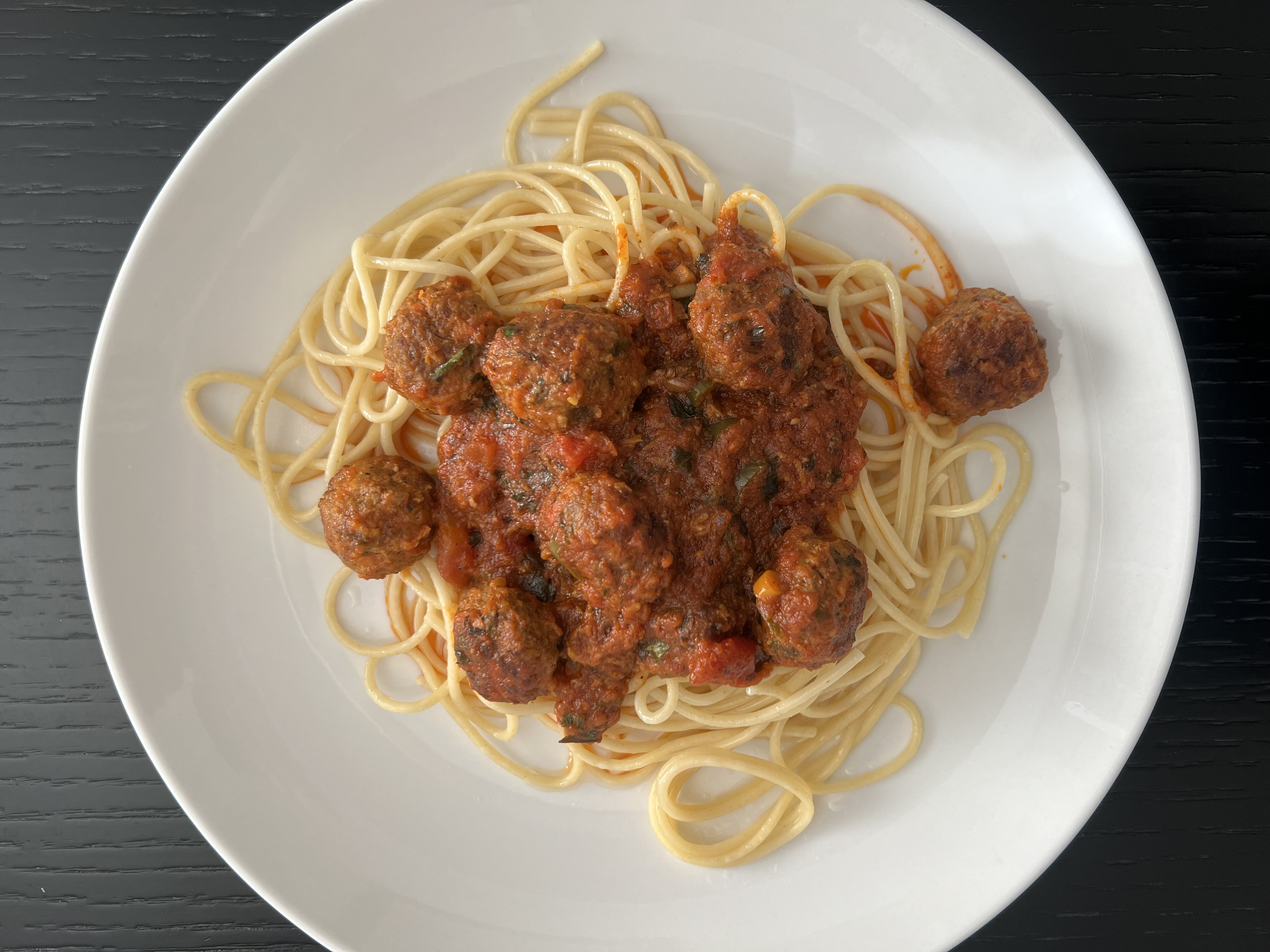 A plate of spaghetti with meatballs, where sauce and starch keep every strand separate